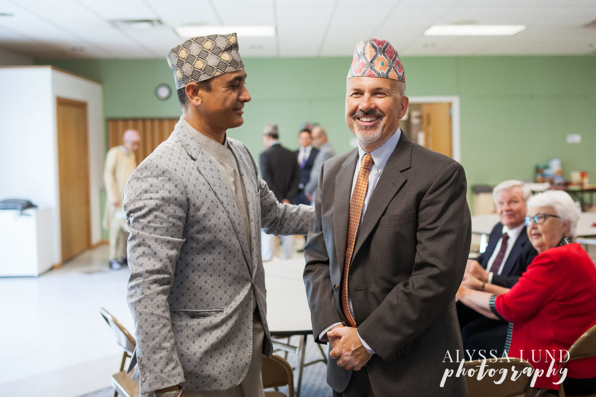 Minneapolis Hindu Wedding uncle sharing Nepali hats