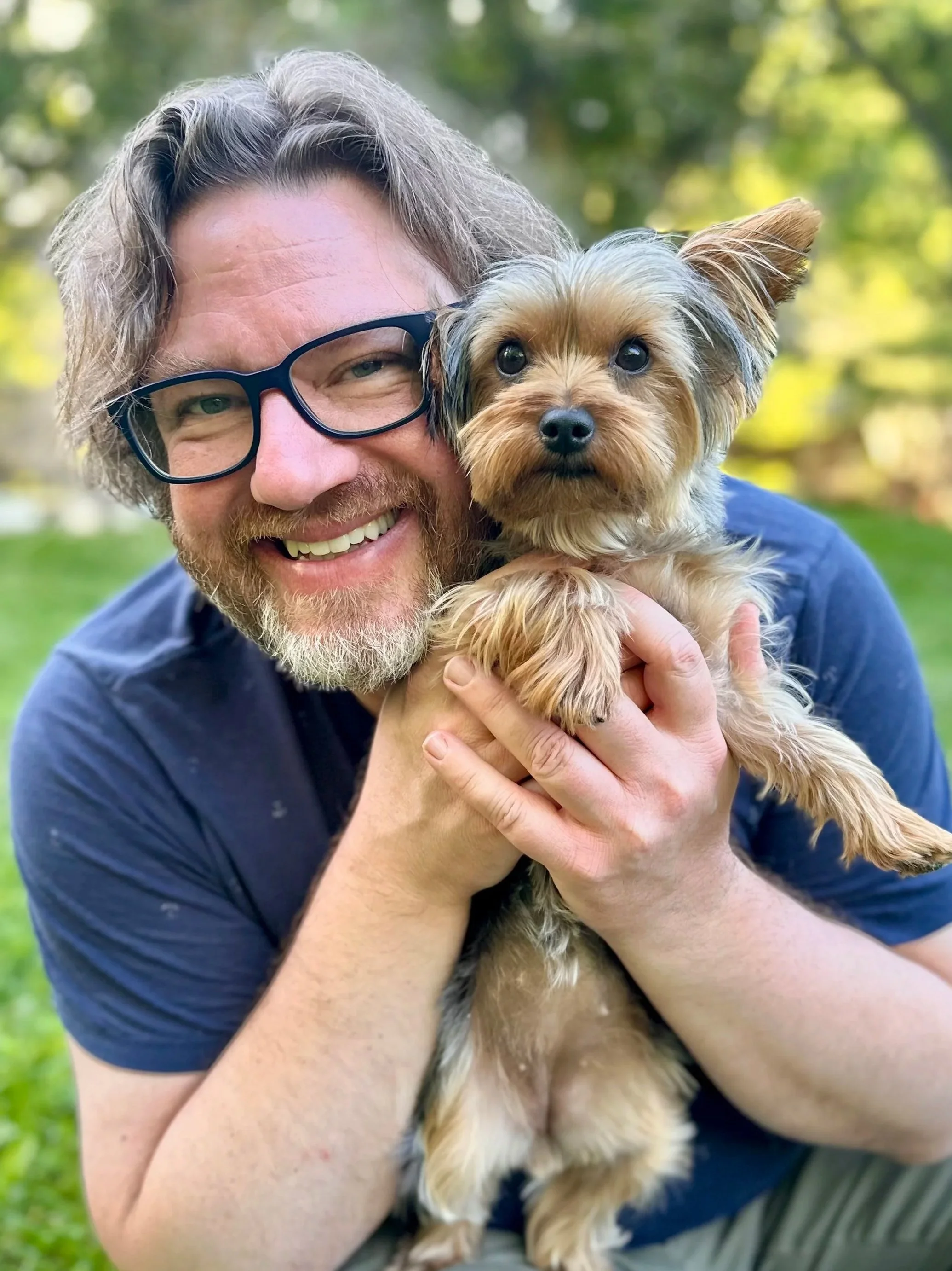 Image of Jason Kelly holding a Yorkie