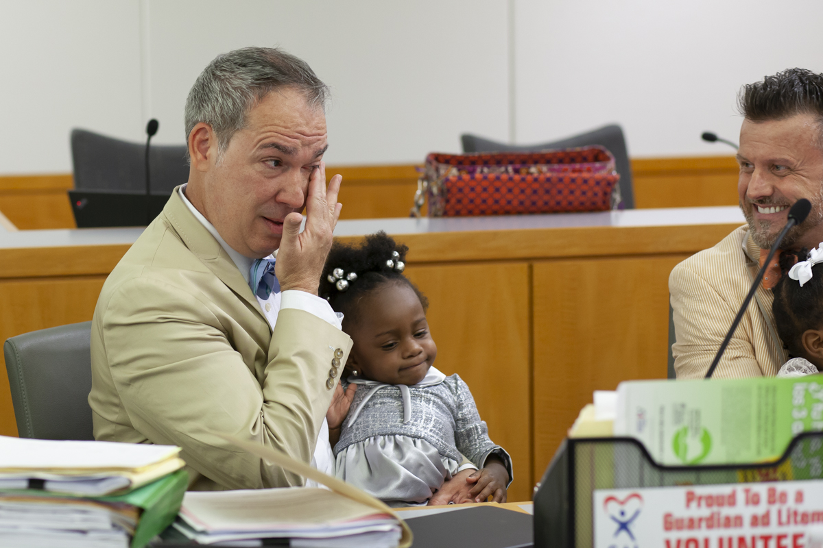 Men crying at their adoption in Miami Courthouse