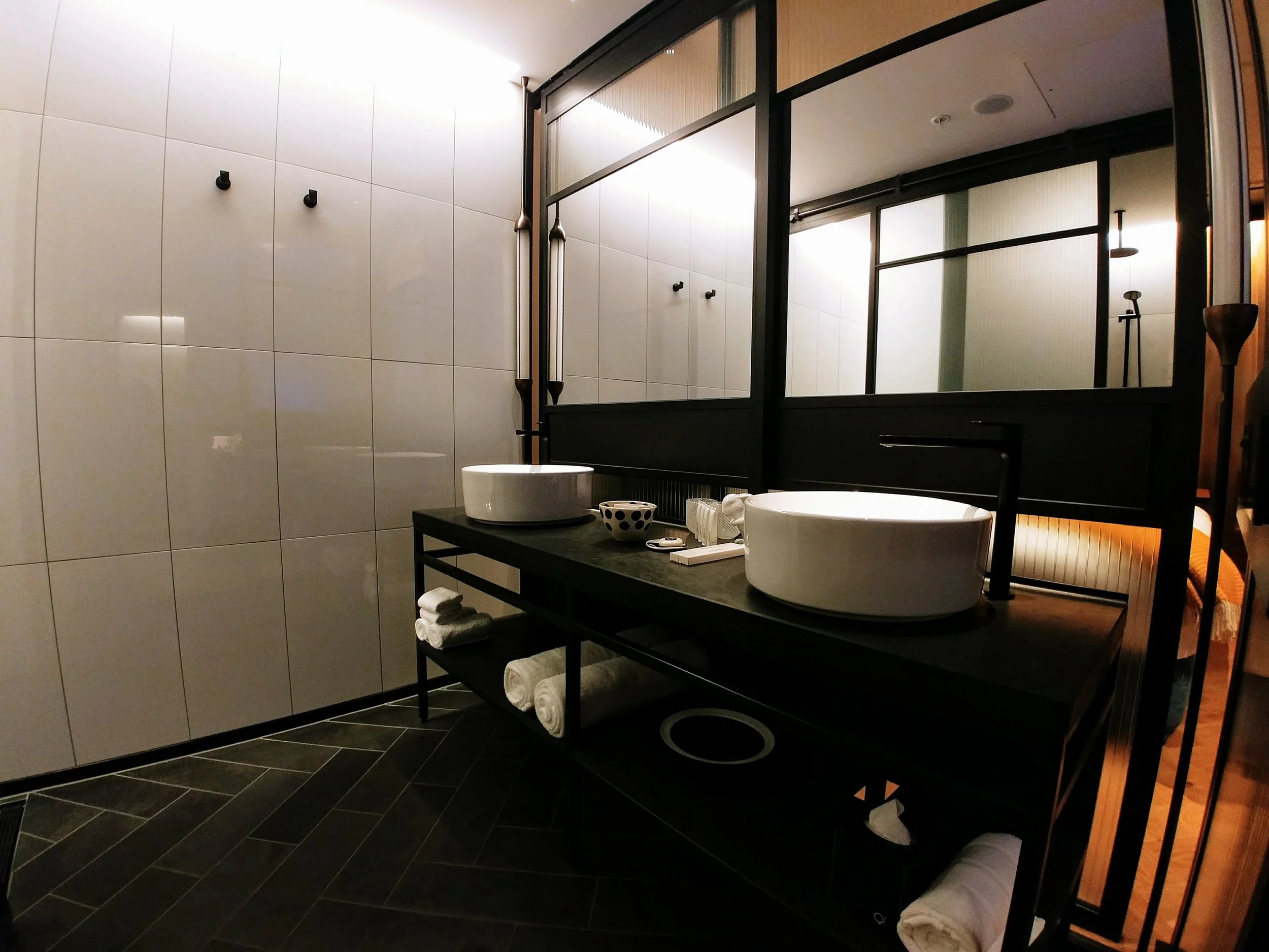 The mirror walls in front of the double vanity can be adjusted like a roller door so you can watch TV or talk to your partner on the bed while washing your hands/face/brushing your teeth