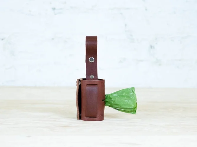 The Roman Dog Standard Waste Bag Dispenser is handcrafted from leather in the USA