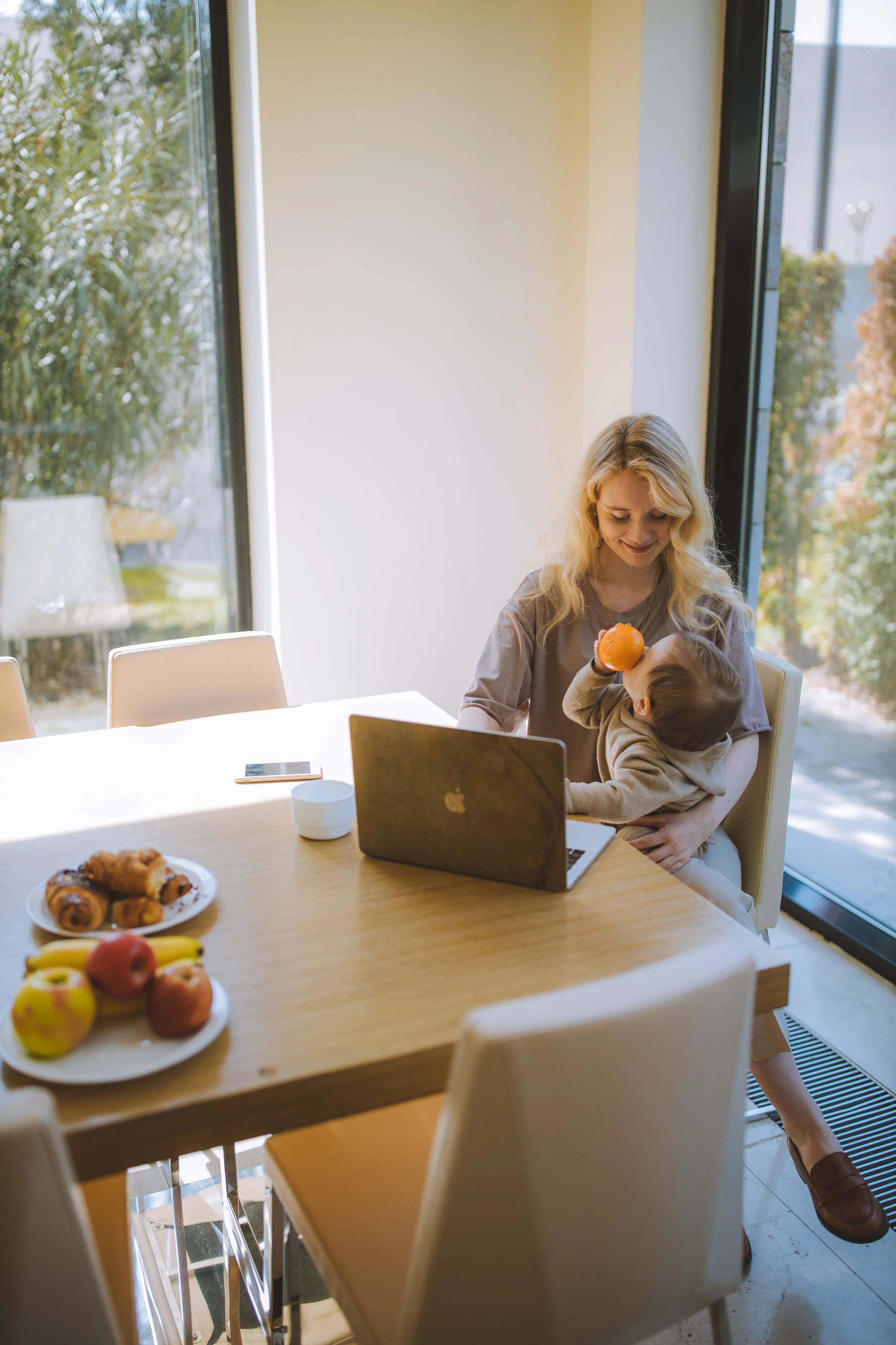 woman-with-her-baby-having-breakfast-and-working-4079293.jpg