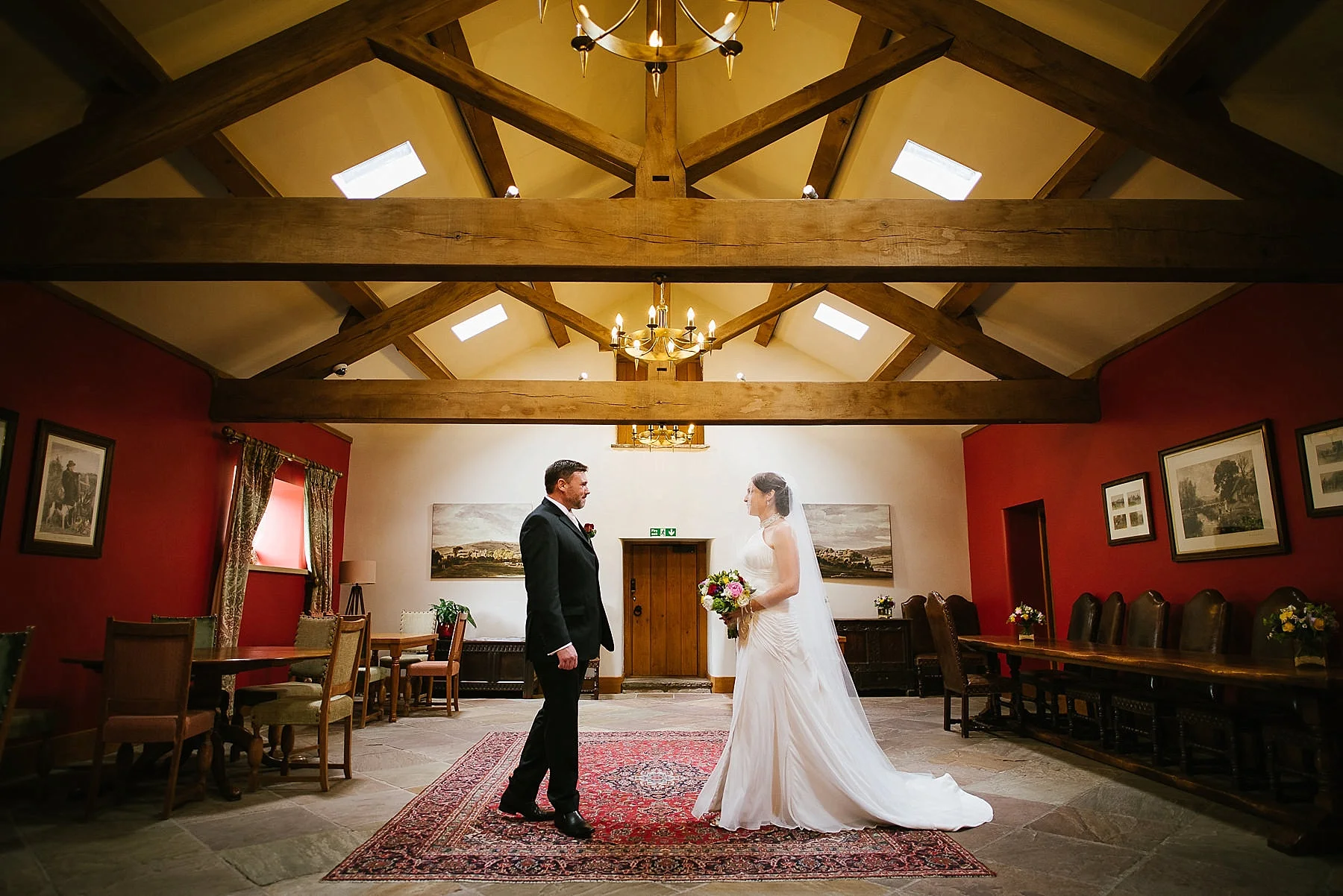 The bride and groom walk towards each other inside Browsholme Hall