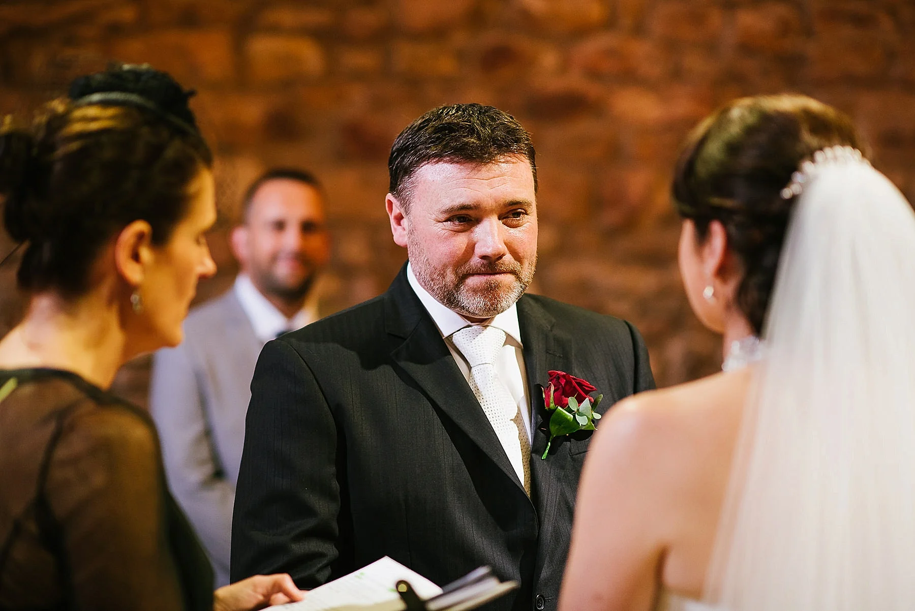 Groom looking at bride during the ceremony