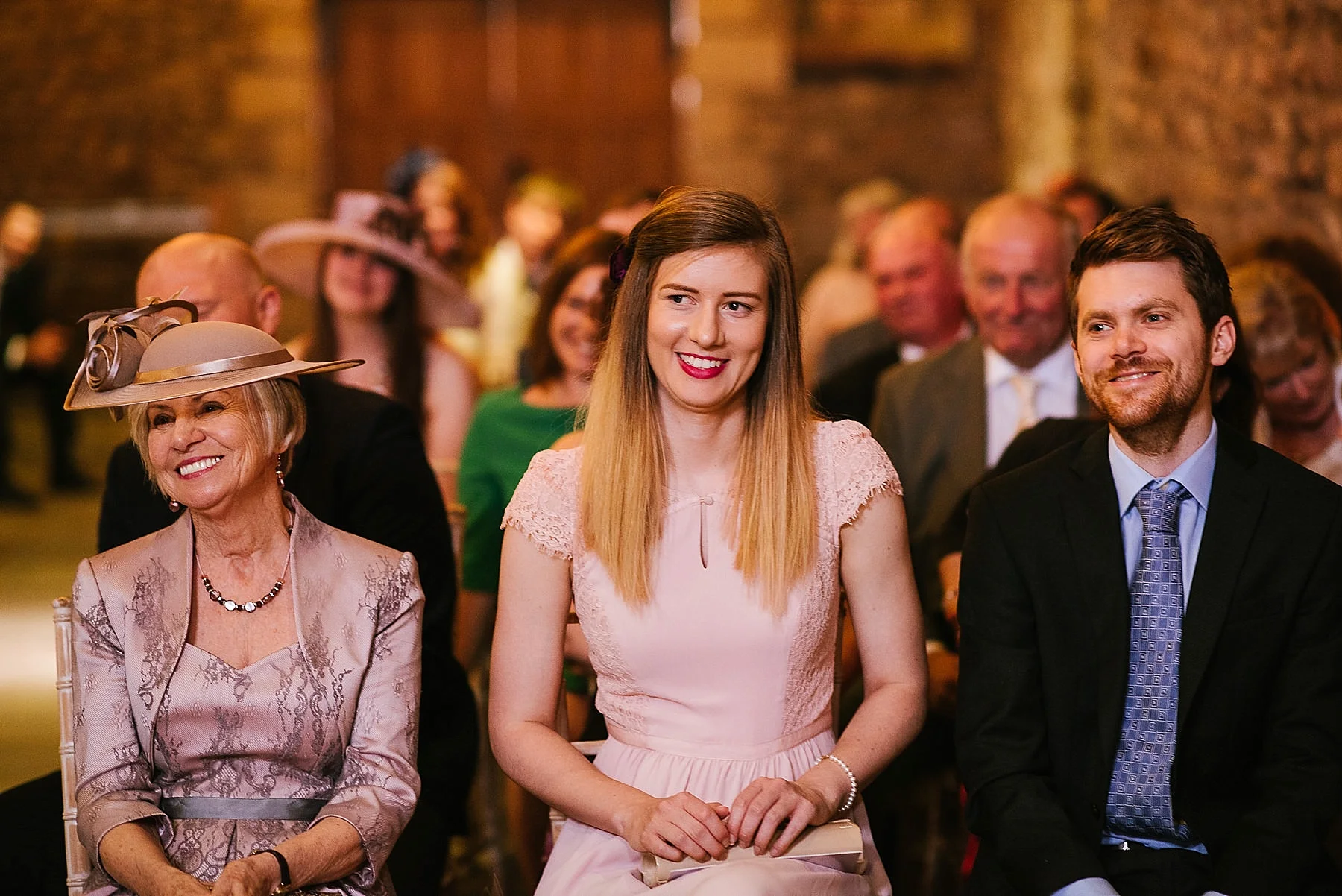 WEdding guests watching the ceremony and smiling