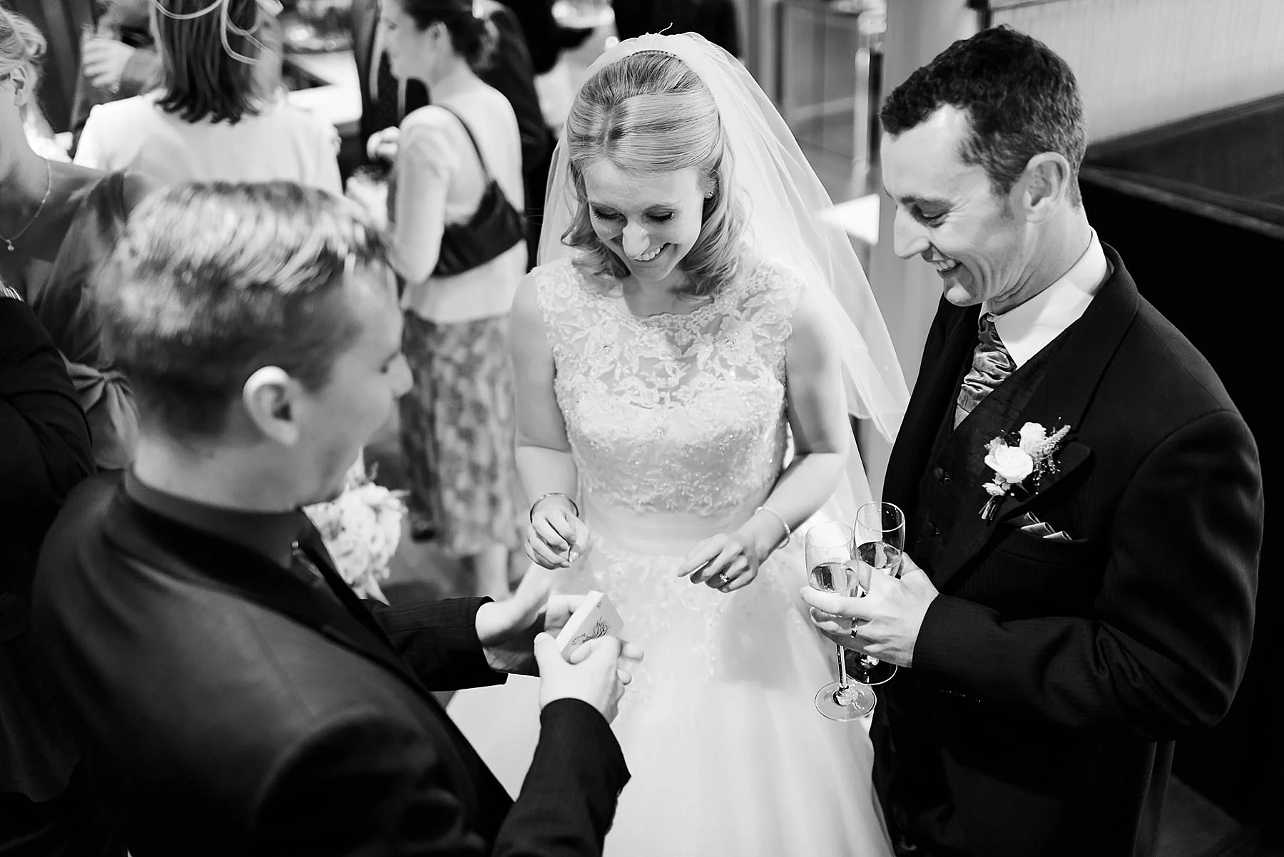 Bride and groom laughing at a magic trick