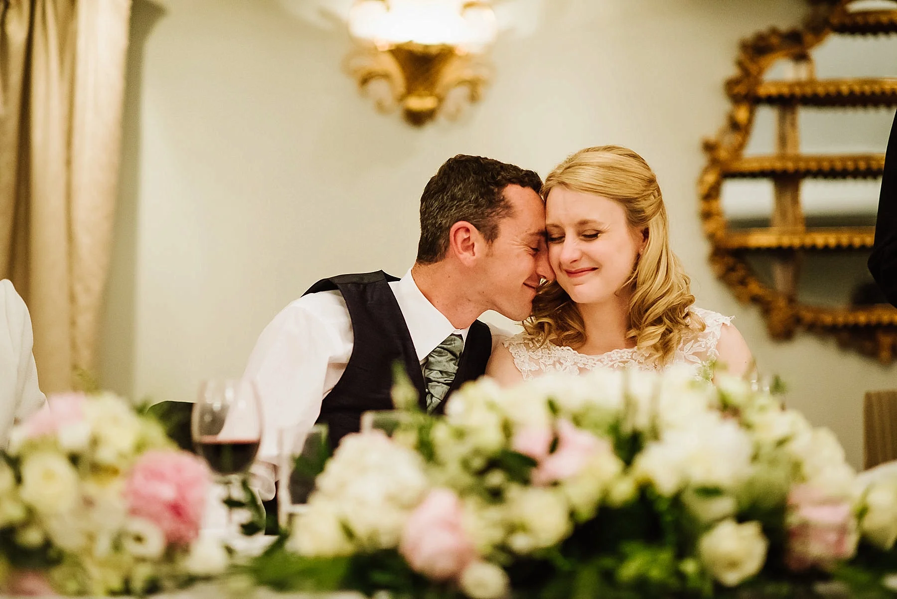 The bride and groom cuddling during the speeches