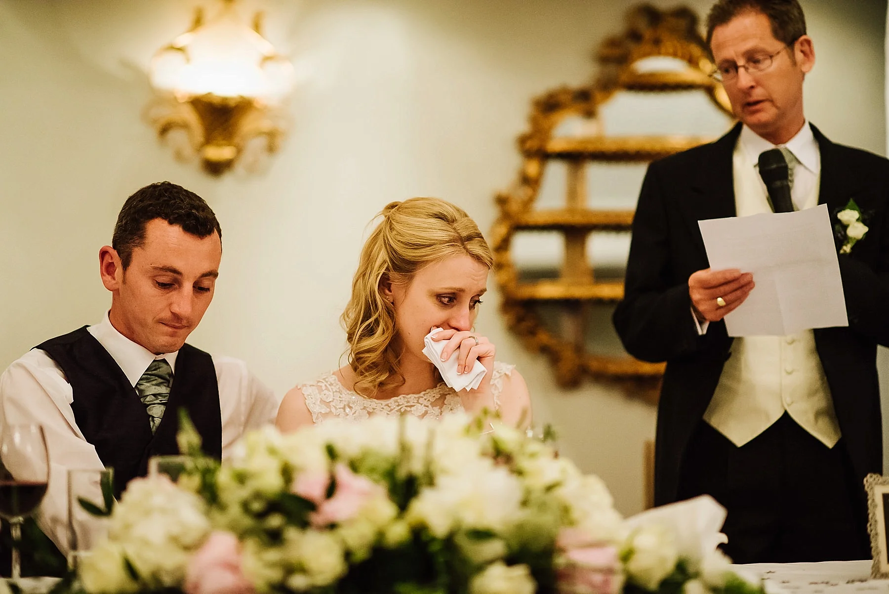 The bride is crying at her father's speech