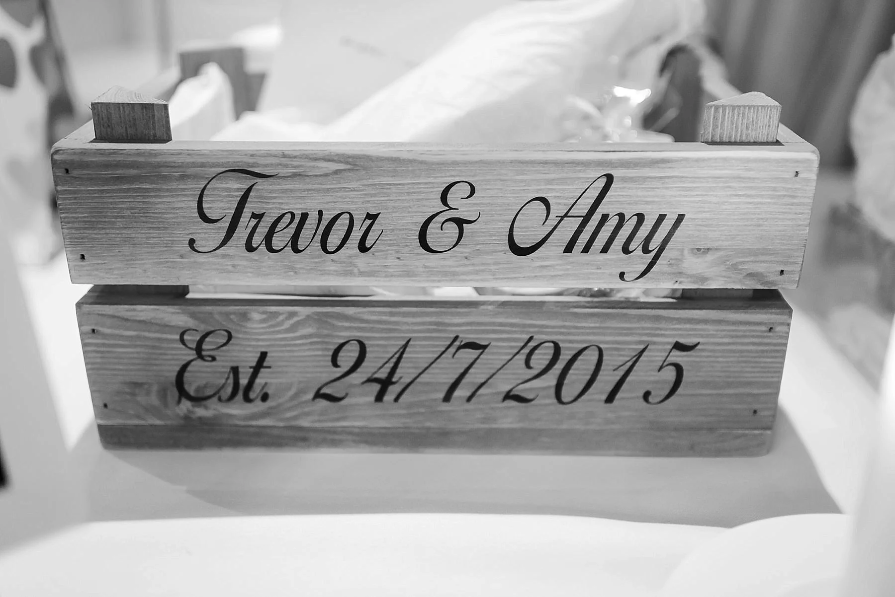 box with words the words Trevor and Amy on and their wedding date