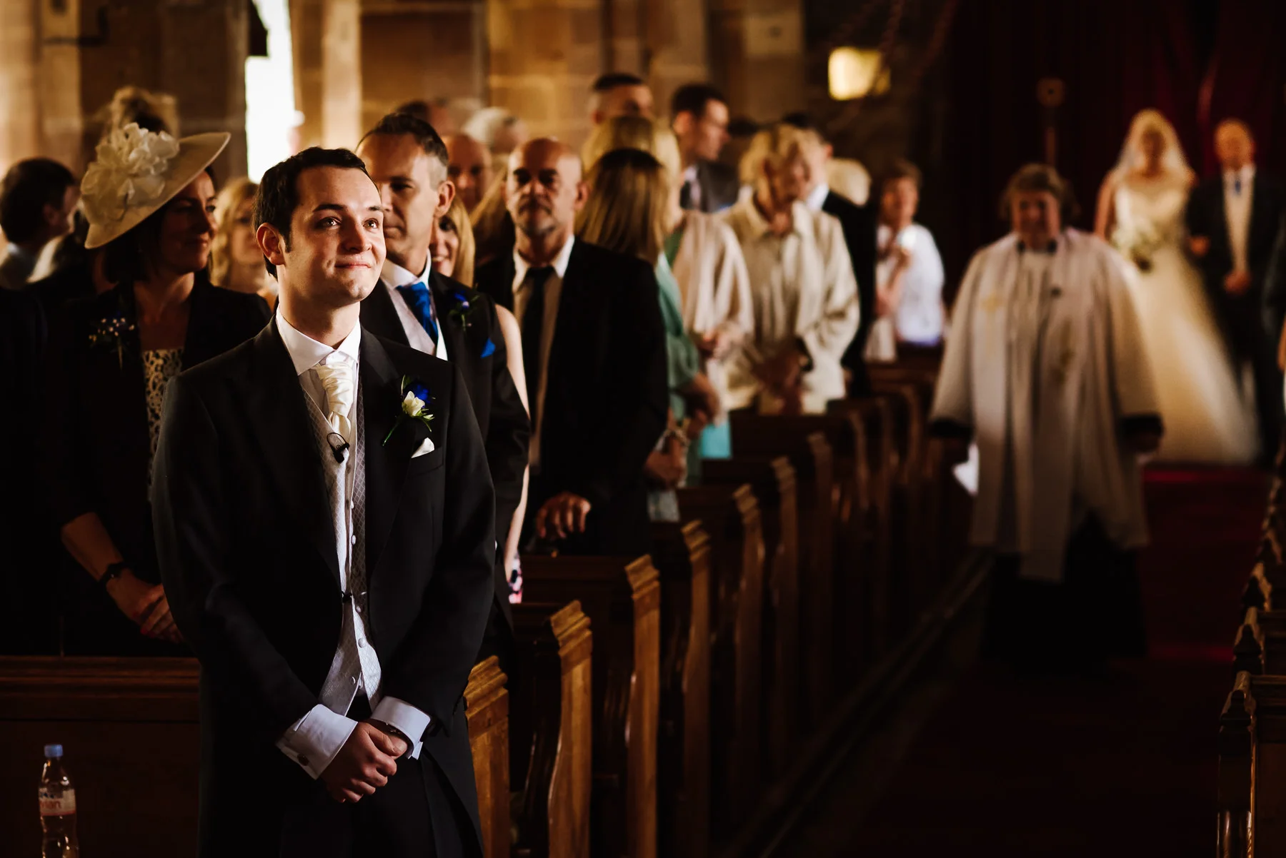 An anxious groom waits for his bride in the church