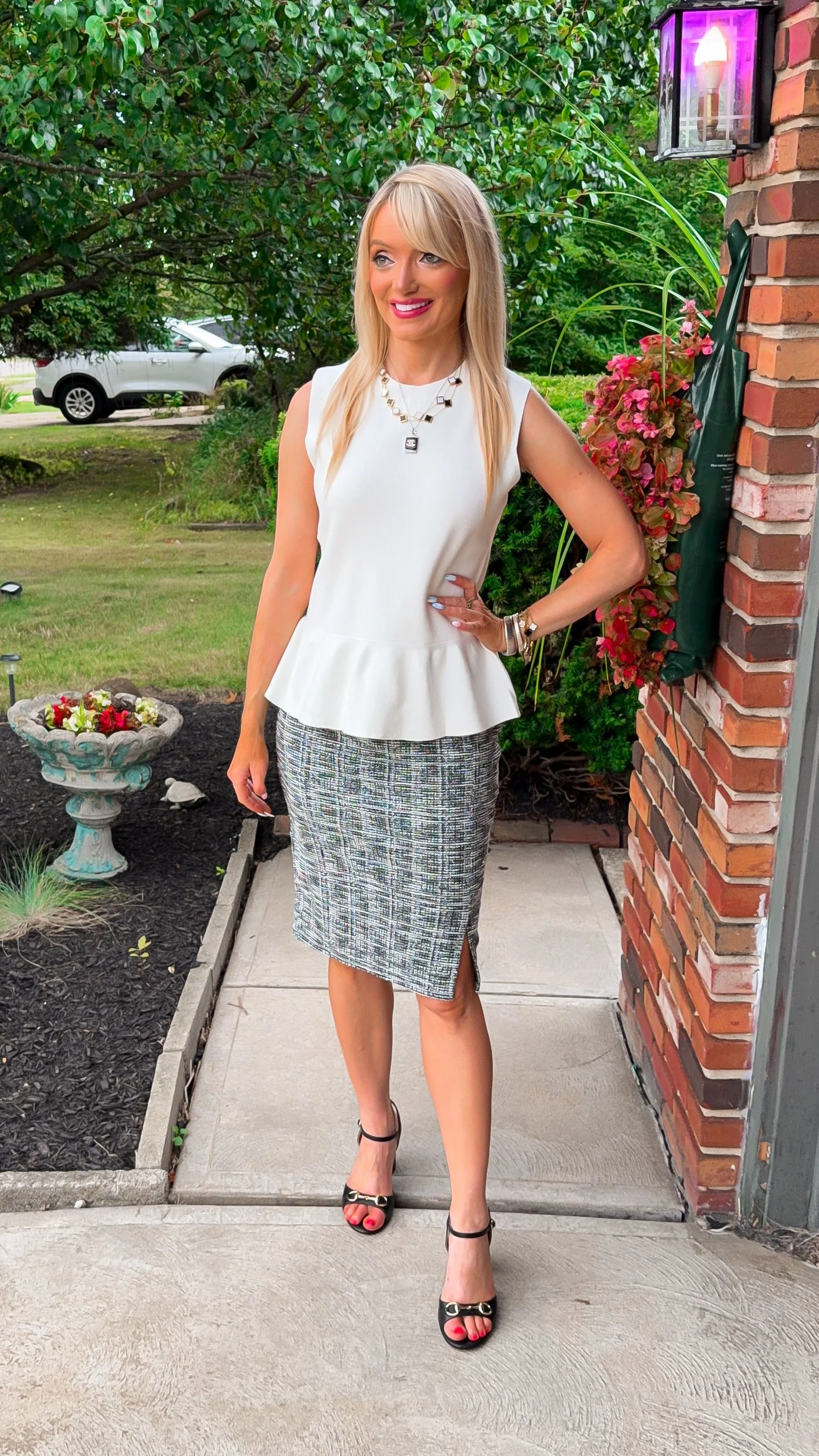  blonde woman dressing for work during late summer into early fall with a knit sleeveless peplum top and tweed pencil skirt all from Amazon  