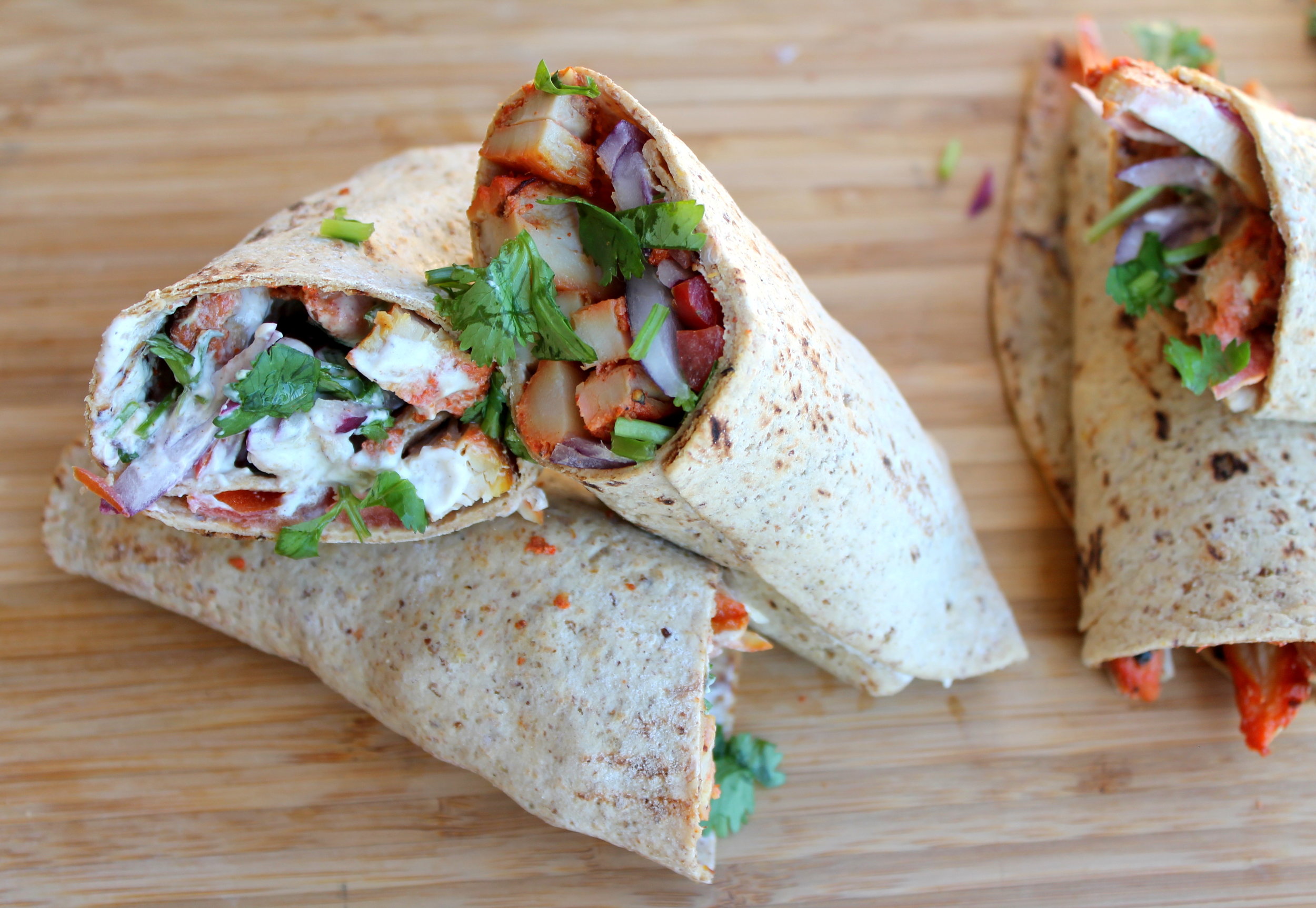 Chicken Tikka Wrap, a quick, healthy, flavorful option for a weeknight dinner or lunch. Juicy chicken tikka pieces are tightly wrapped with delicious spread and toppings. Vegetarian, vegan alternatives available!