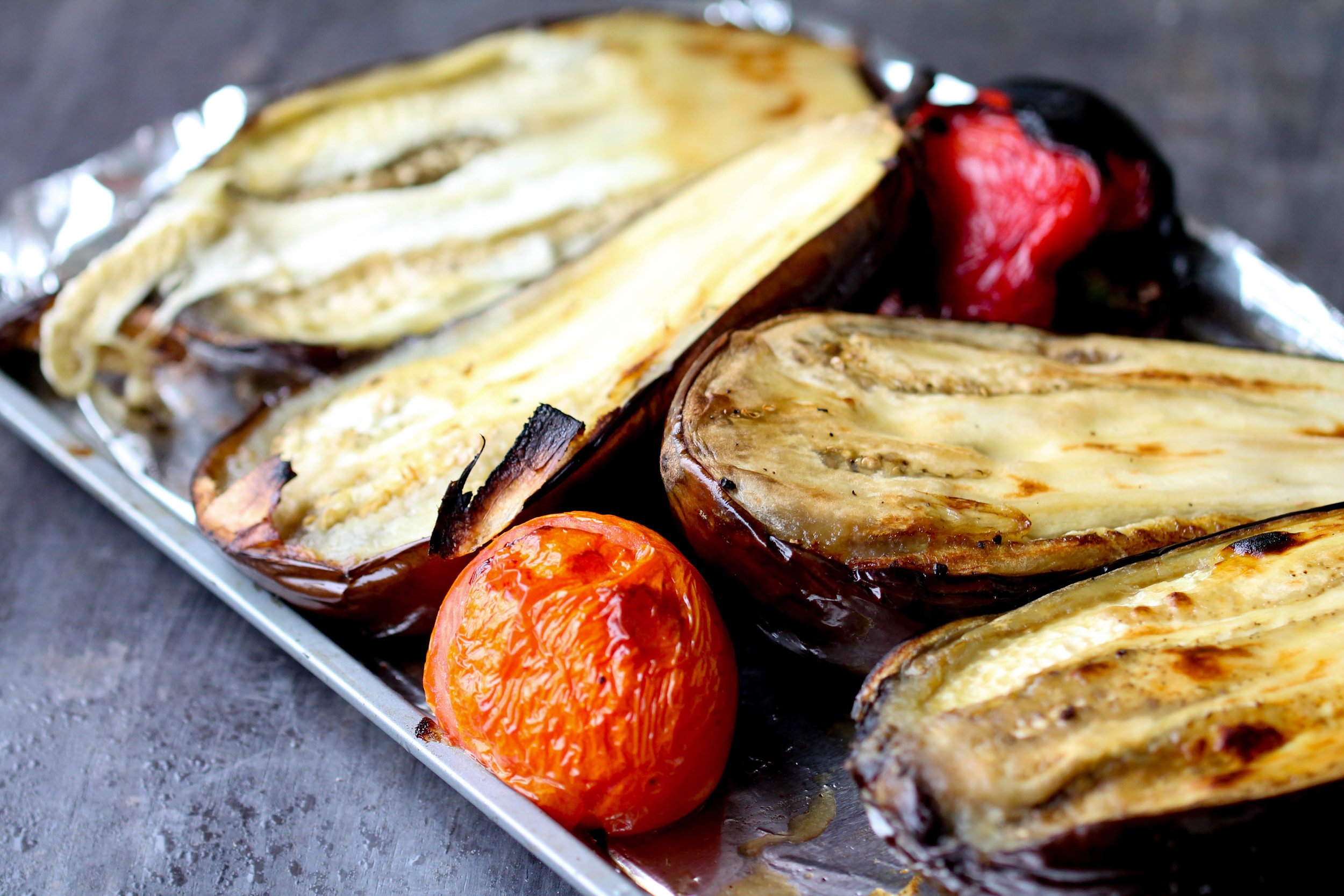 Naturally Vegan, Gluten-Free Roasted Eggplant, Bell Peppers, and Tomato Salad! It works great as side, filling for a quick wrap, or use it as pizza base