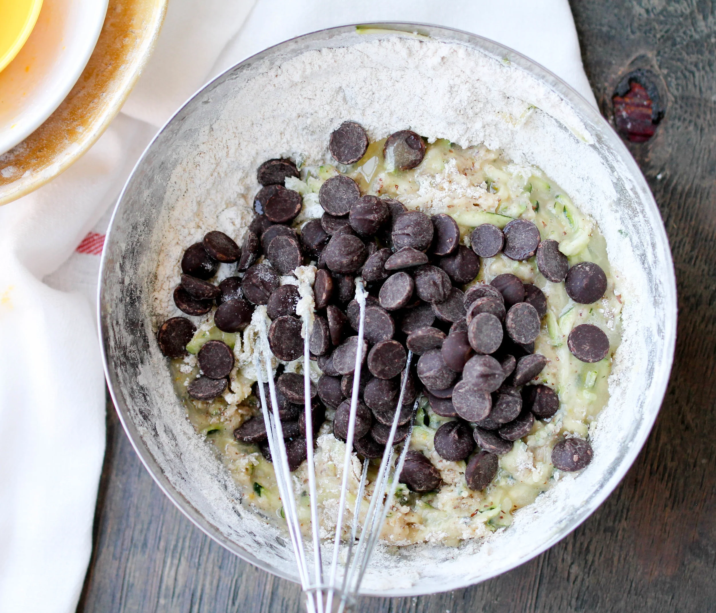 Chocolate Chip Zucchini Muffins are insanely delicious, tender, and easy. Make a batch using leftover zucchini and enjoy them for a quick snack or dessert!
