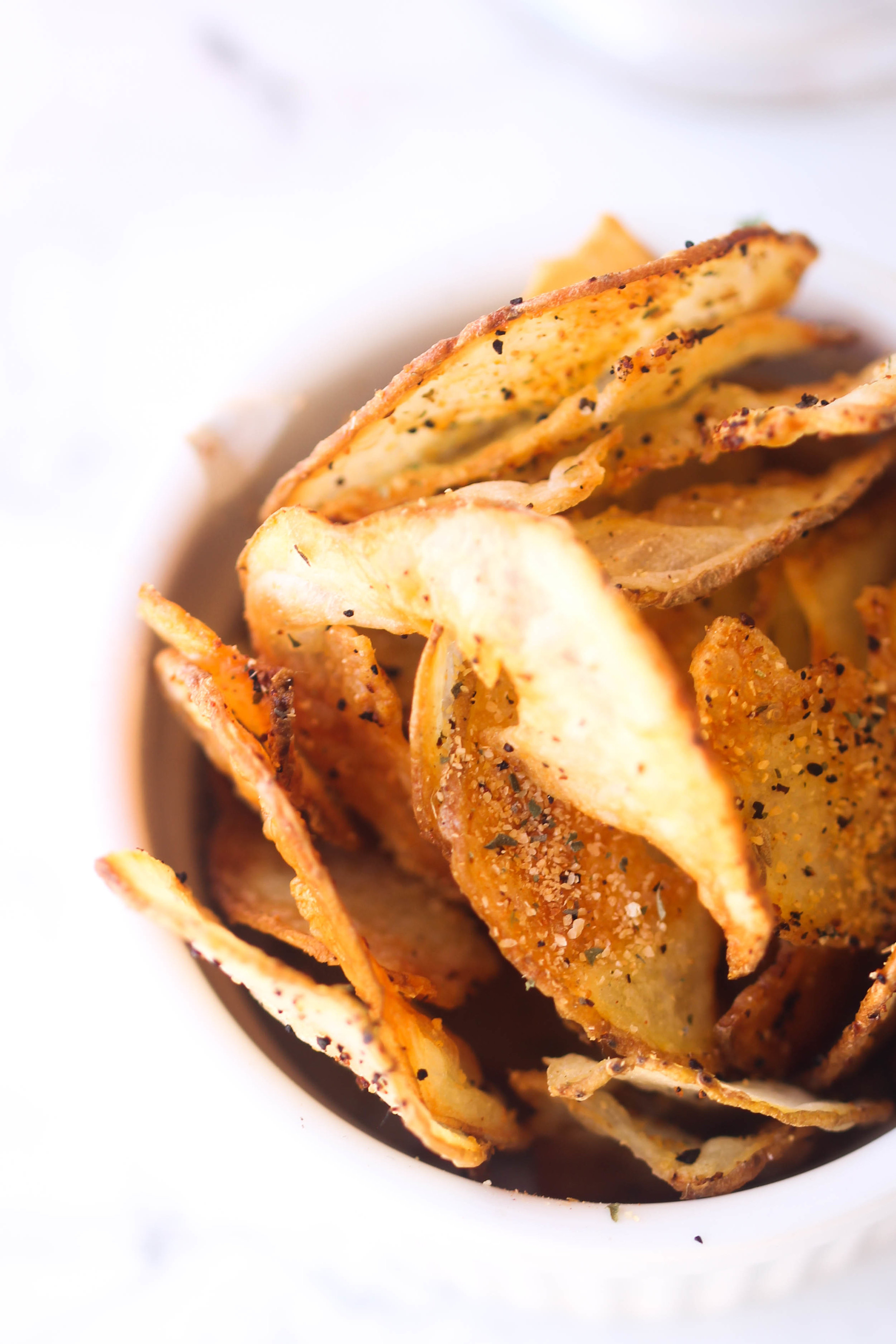 Crispy Baked Potato Chips are a healthier alternative to store-bought potato chips. They take 30 minutes or less and you can easily customize your spices.