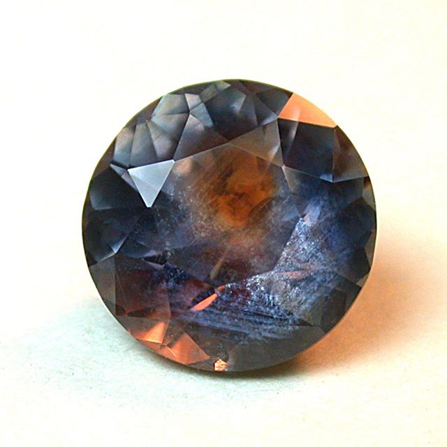 Sapphire, from the Rock Creek district of Montana, a faceted 8mm round brilliant weighing 2.40 carats. Color zoning in Montana sapphires is ubiquitous. The zoning makes it almost impossible to predict the color of a finished gemstone. This amazing st