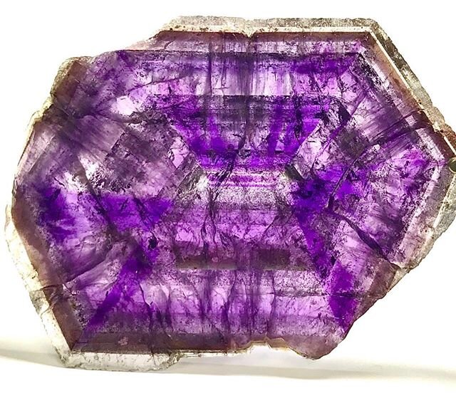 A slice of a large amethyst crystal, measuring 9 x 6 cm, showing the intense zoning that occurs during crystal growth. Quartz is one of many minerals that exhibit this phenomenon, but &ldquo;phantoms&ldquo; in quartz are ubiquitous. They are the resu