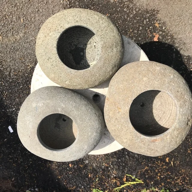 River stone flower pots with a hole in the bottom