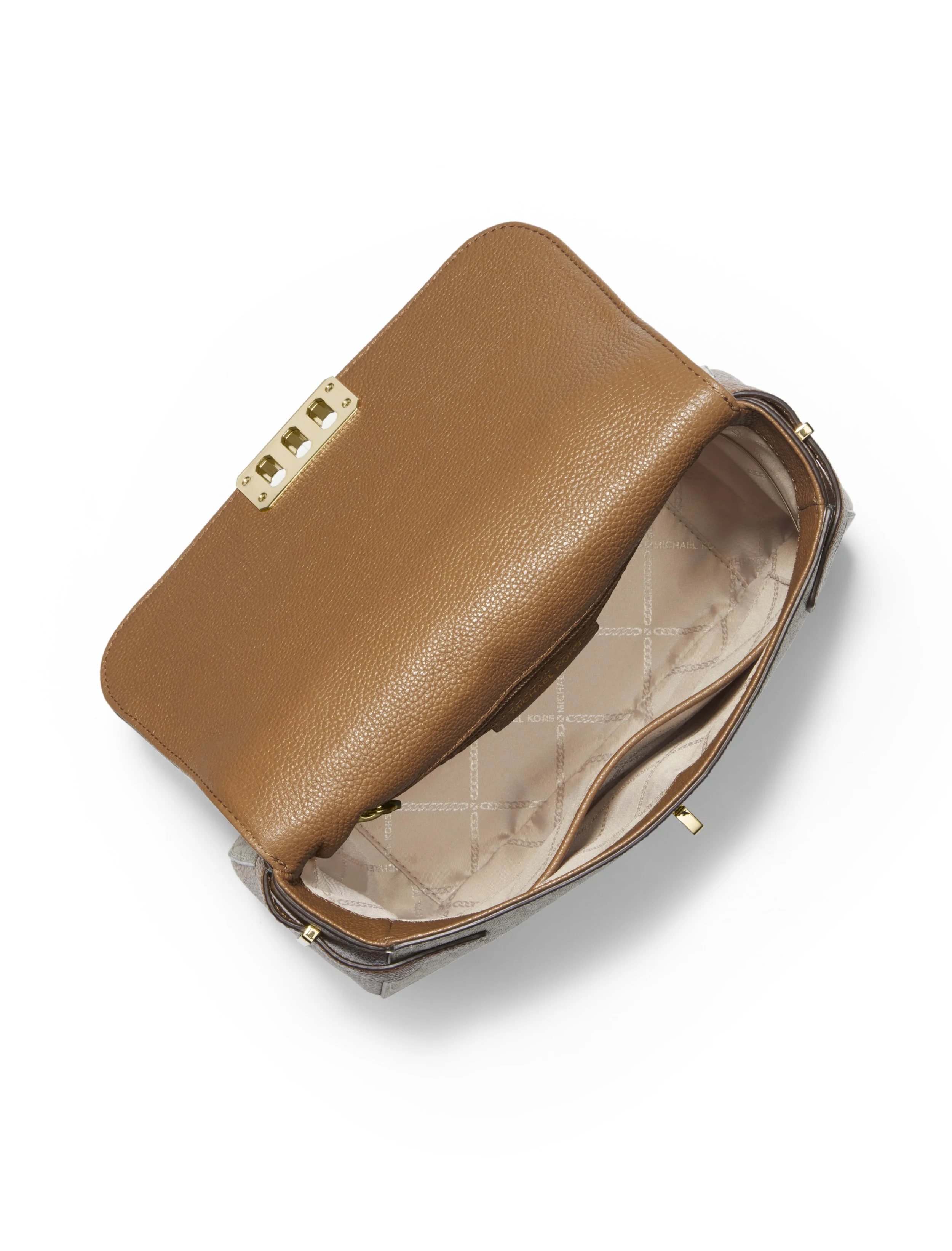 A tan leather handbag with gold hardware inside an open pink and brown patterned purse