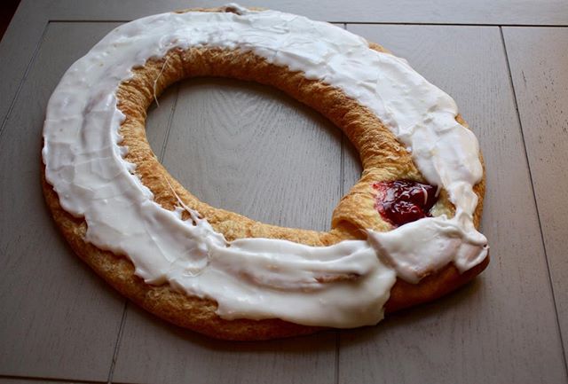 Do you know what a Wisconsin Kringle is? It was originated in Racine Wisconsin and is a Danish pastry. It is folded over and over to create the unique flaky dough and then it is filled with brown sugar cinnamon filling along with the filling of your 