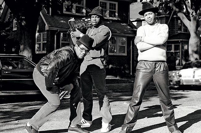 This shows RUN-D.M.C. in 1983 before they all started rocking Adidas sneakers