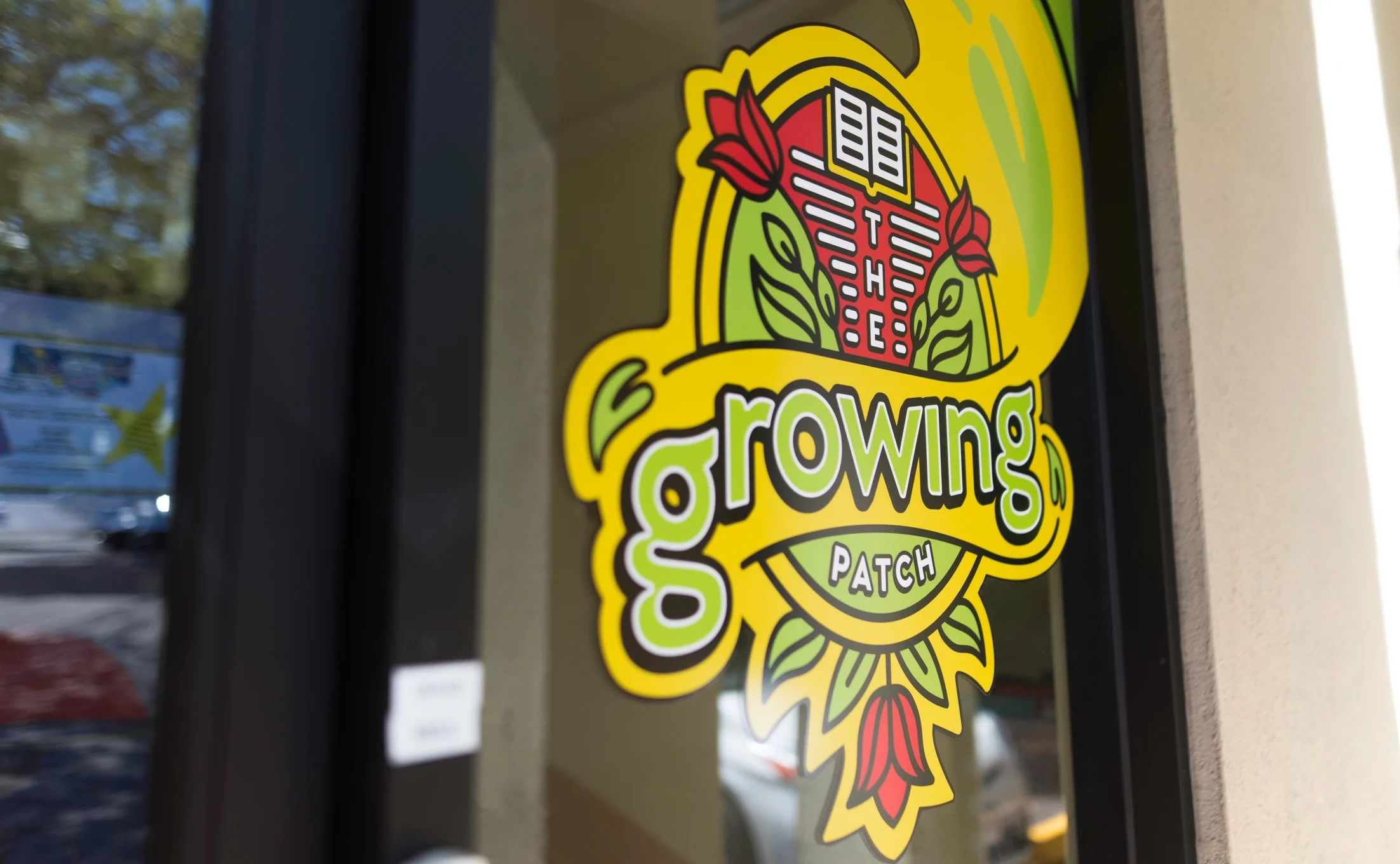 The Growing Patch—Storefront Vinyl Graphics at Leftward Angle of Logo
