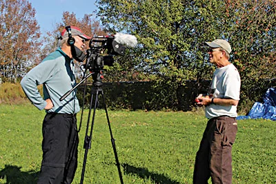 Huey Coleman filming John Bunker collecting wild apples, for Coleman's next documentary, "Henry David Thoreau: Surveyor of the Soul.” photo by Judy Wentzell