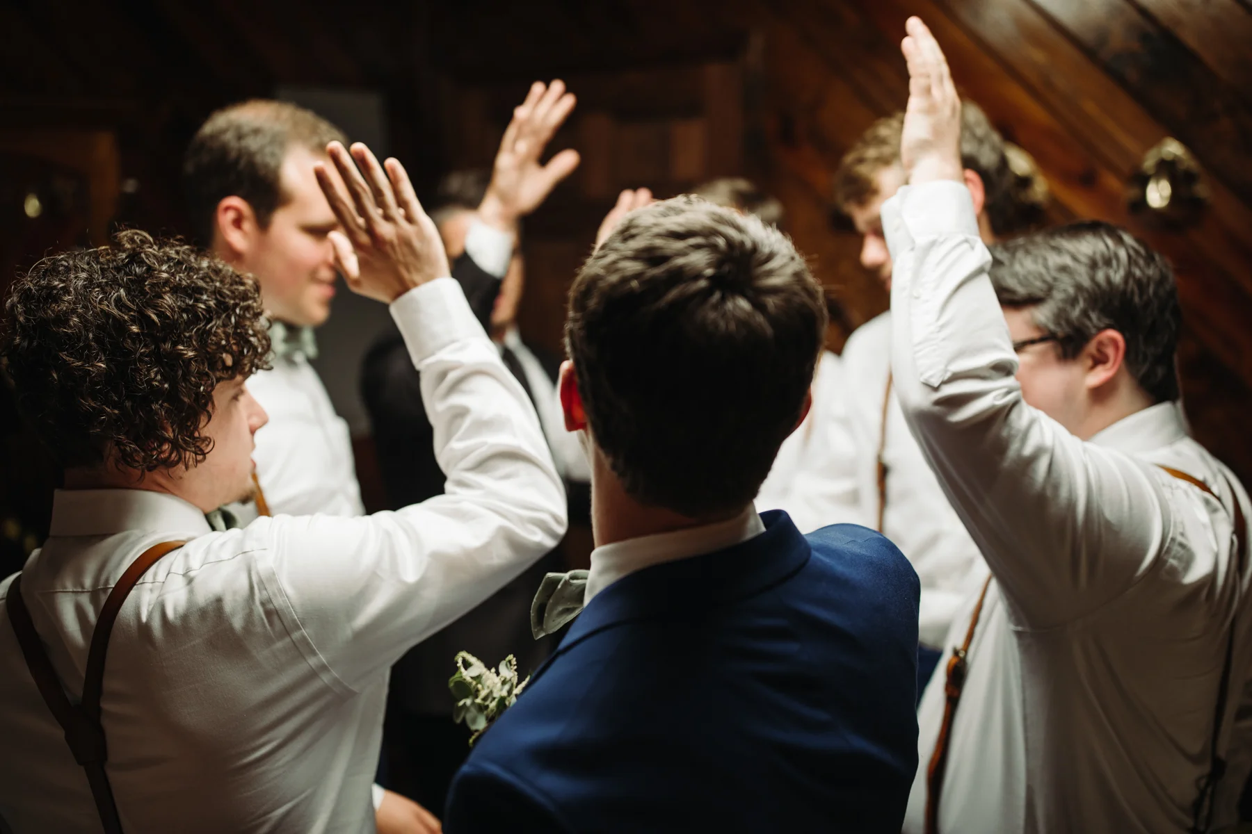 Groomsmen pray and give a cheer before a stables at strawberry creek wedding in Knoxville, tennessee