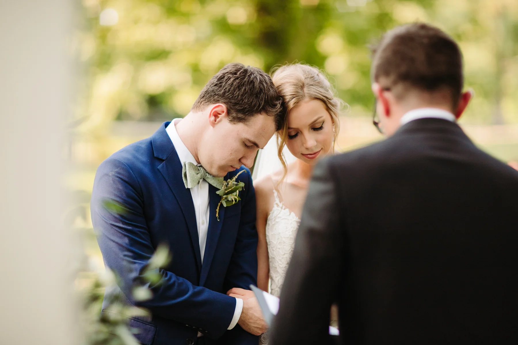 Bride and groom from behind at the altar of a stables at strawberry creek wedding in knoxville, tennessee
