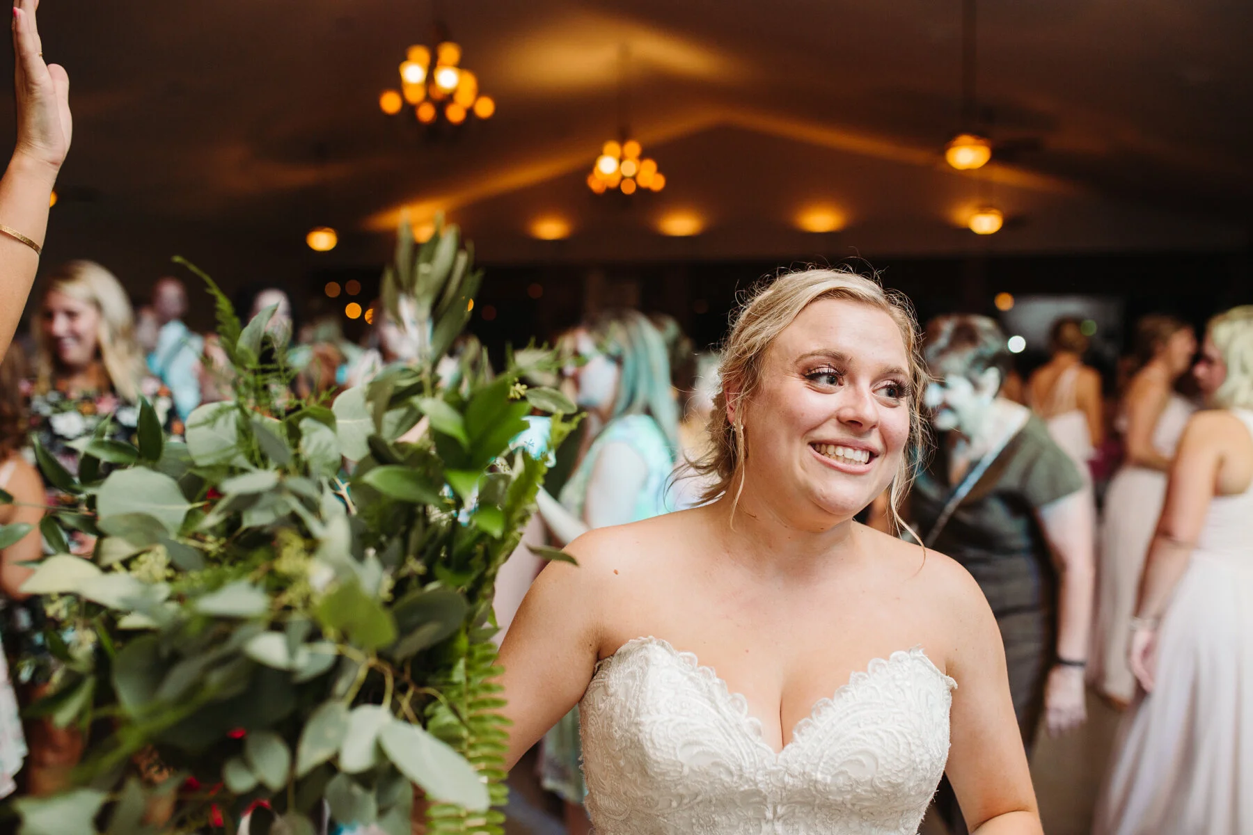 bouquet toss during the reception at a sunny outdoor wedding at hunter valley farms in knoxville tennessee