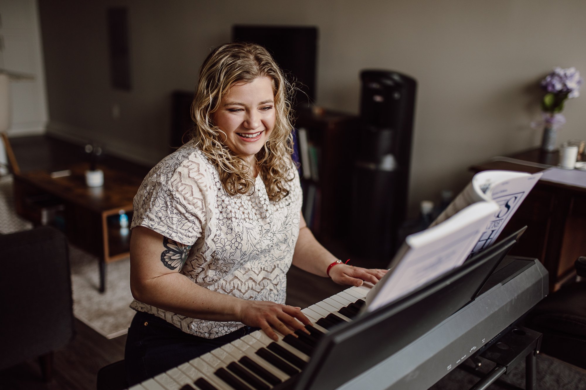 Nashville Commercial Photography - musician and voice teacher playing the piano in her studio