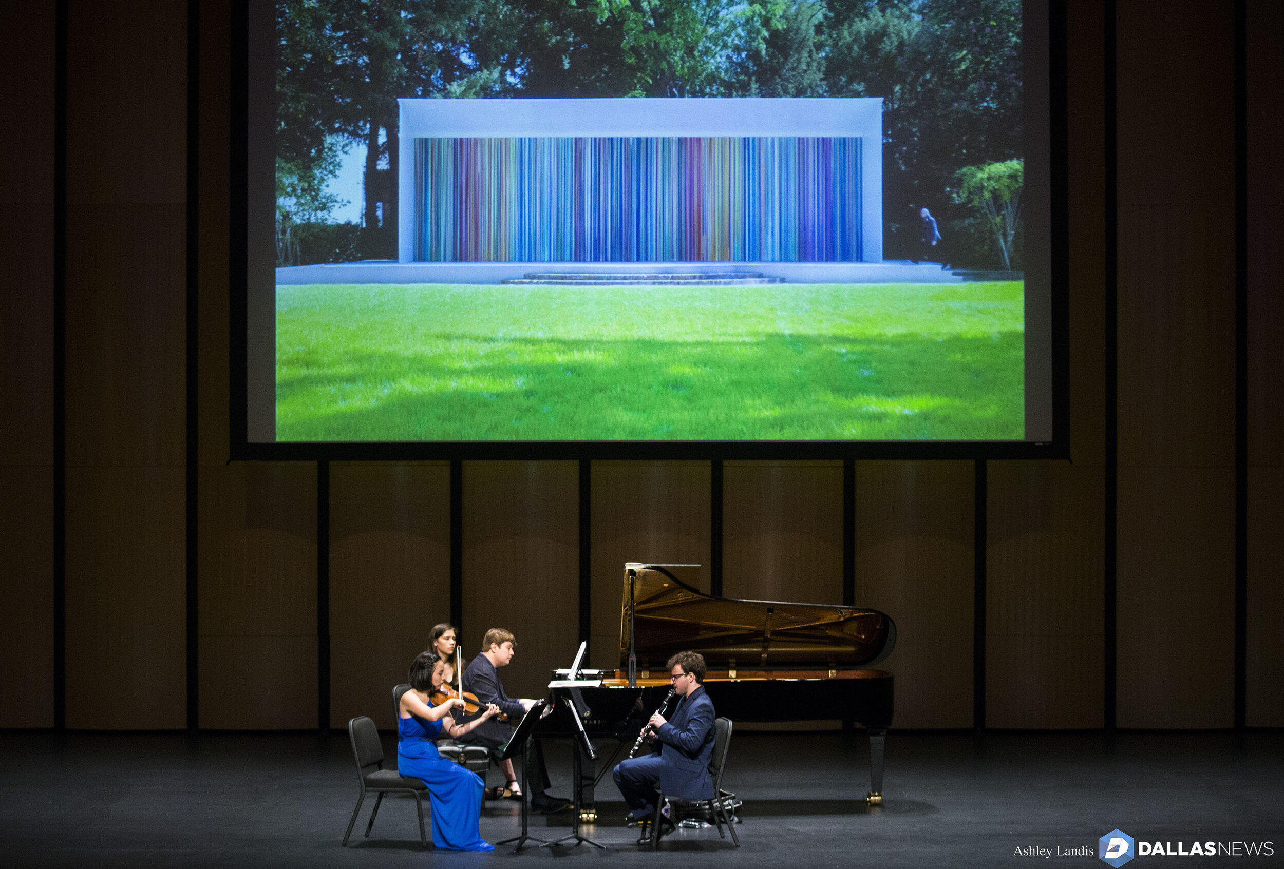  Violinist Grace Kang Wollett, pianist Mikhail Berestnev and clarinetist Danny Goldman rehearse under a photo of "Horizons," artwork by Ian Davenport, before a Basically Beethoven Festival concert on Sunday, July 7, 2019 at Moody Performance Hall in 