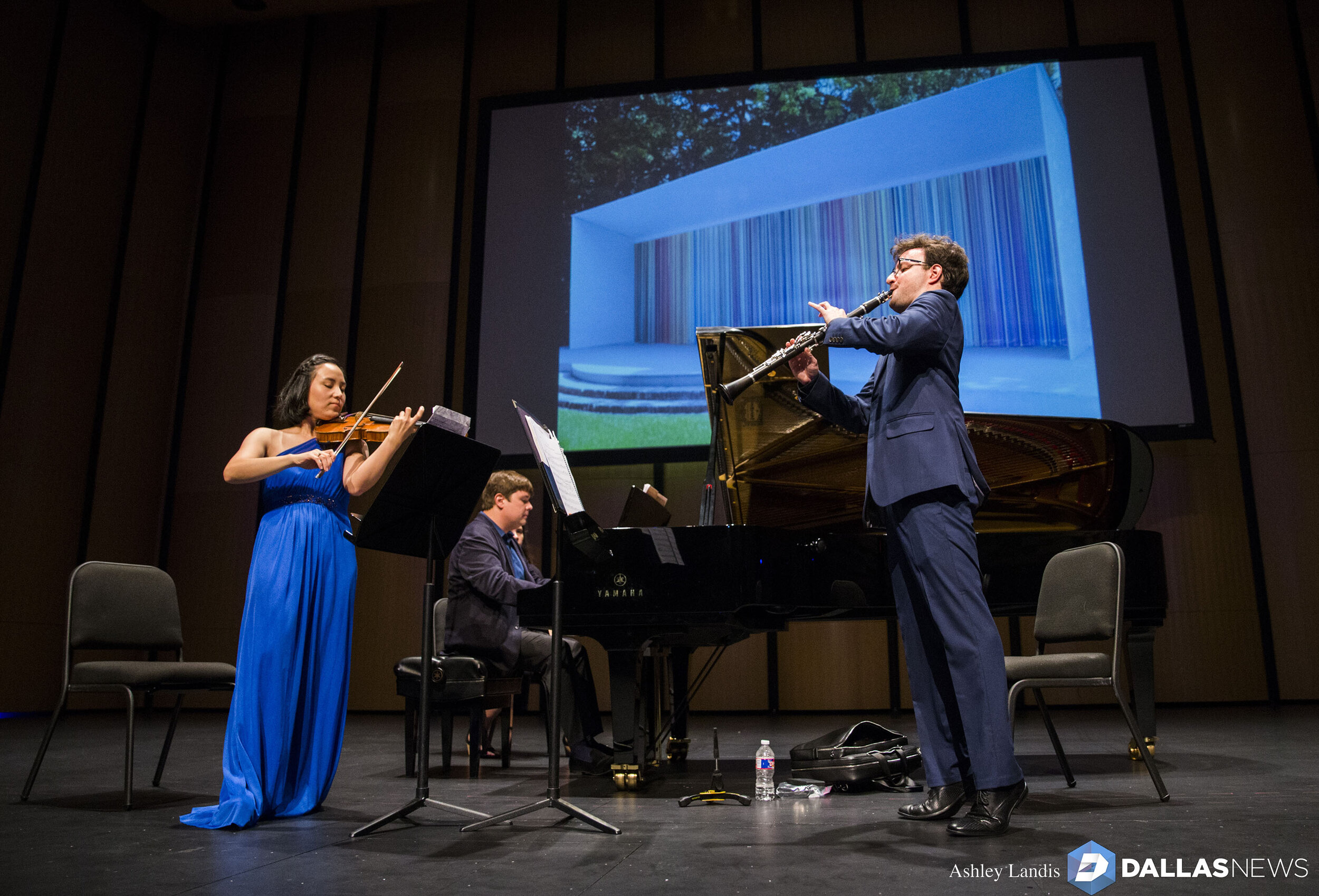  Violinist Grace Kang Wollett, pianist Mikhail Berestnev and clarinetist Danny Goldman rehearse under a photo of "Horizons," artwork by Ian Davenport, before a Basically Beethoven Festival concert on Sunday, July 7, 2019 at Moody Performance Hall in 