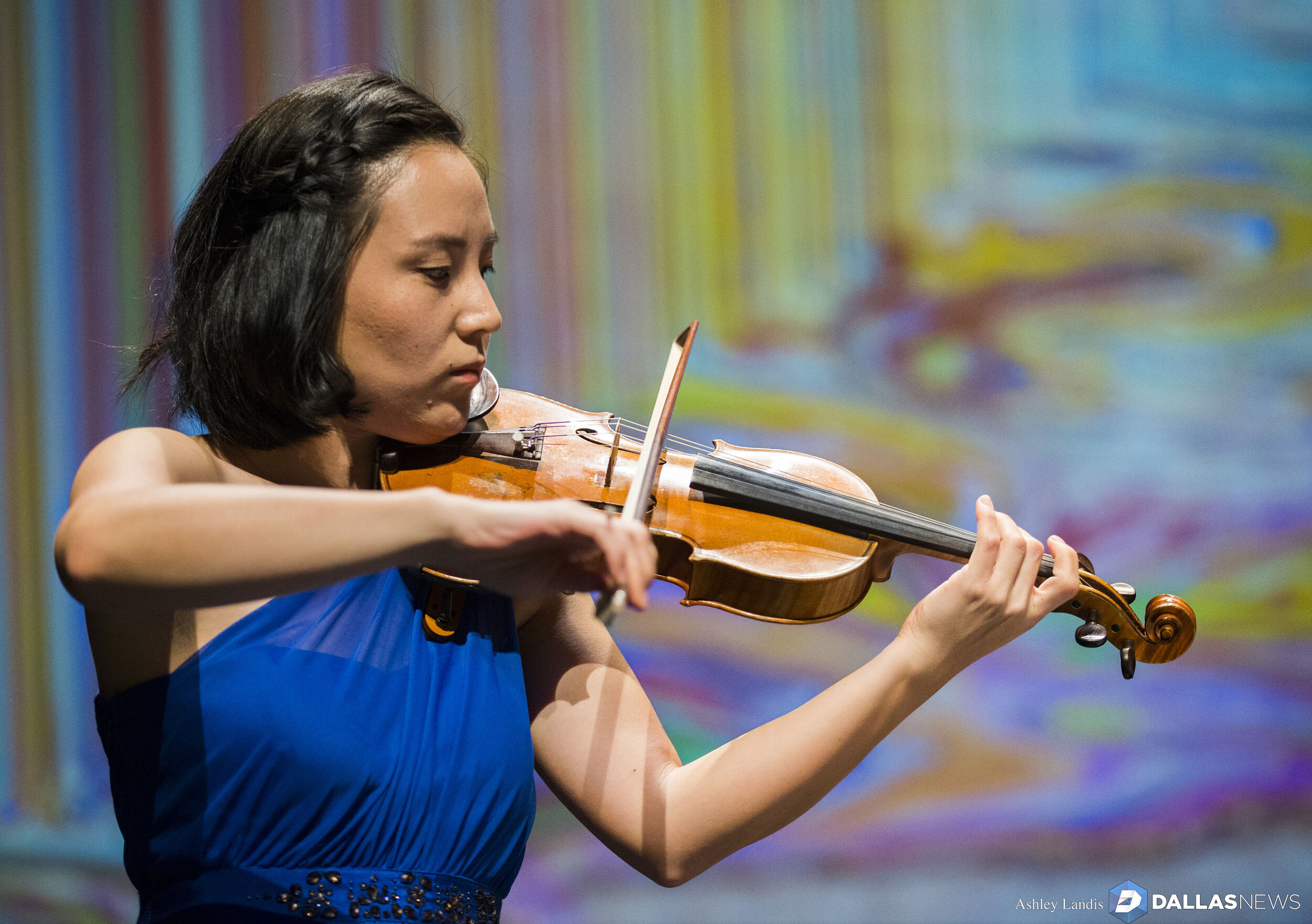  Violinist Grace Kang Wollett rehearses under a photo of "Horizons," artwork by Ian Davenport, before a Basically Beethoven Festival concert on Sunday, July 7, 2019 at Moody Performance Hall in Dallas. Composer Kimberly Osberg was inspired by the art