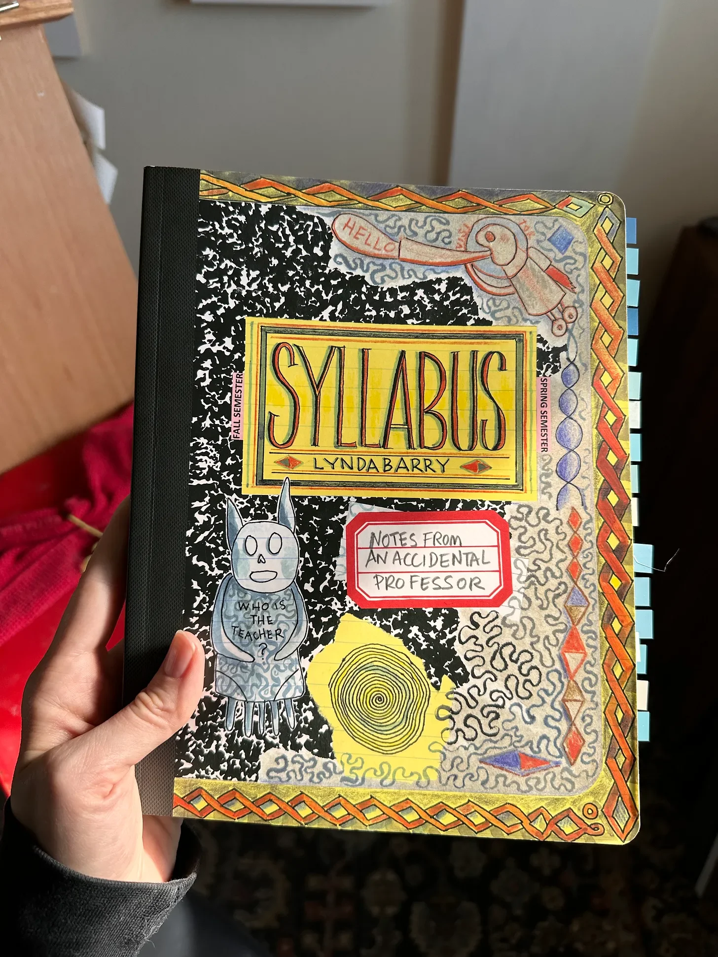 holding my beloved copy of Syllabus by Lynda Barry. I had flagged so many pages from the Library copy in my commonplace notebook I ordered my own copy!