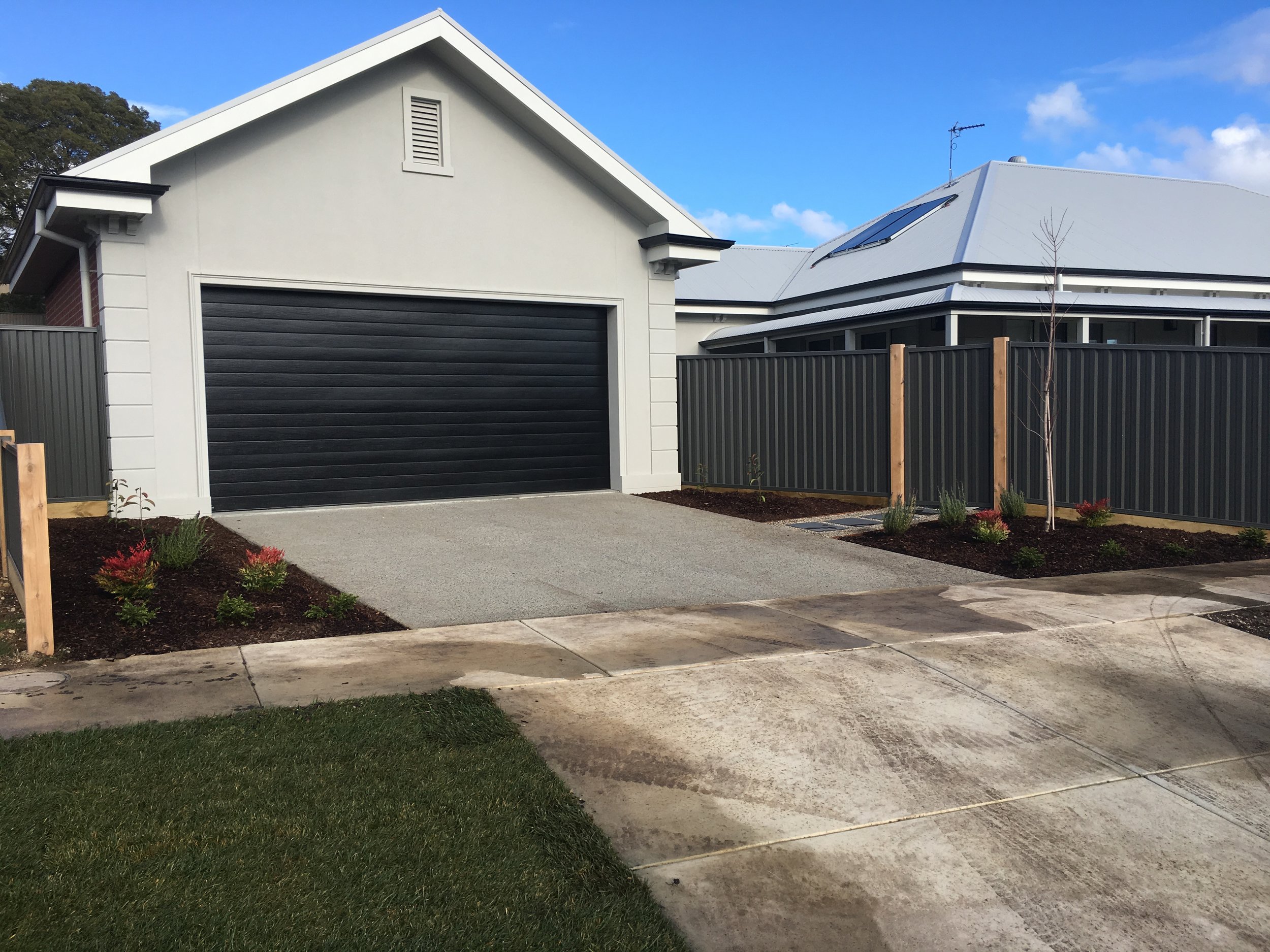 Garden beds and exposed aggregate driveway pad