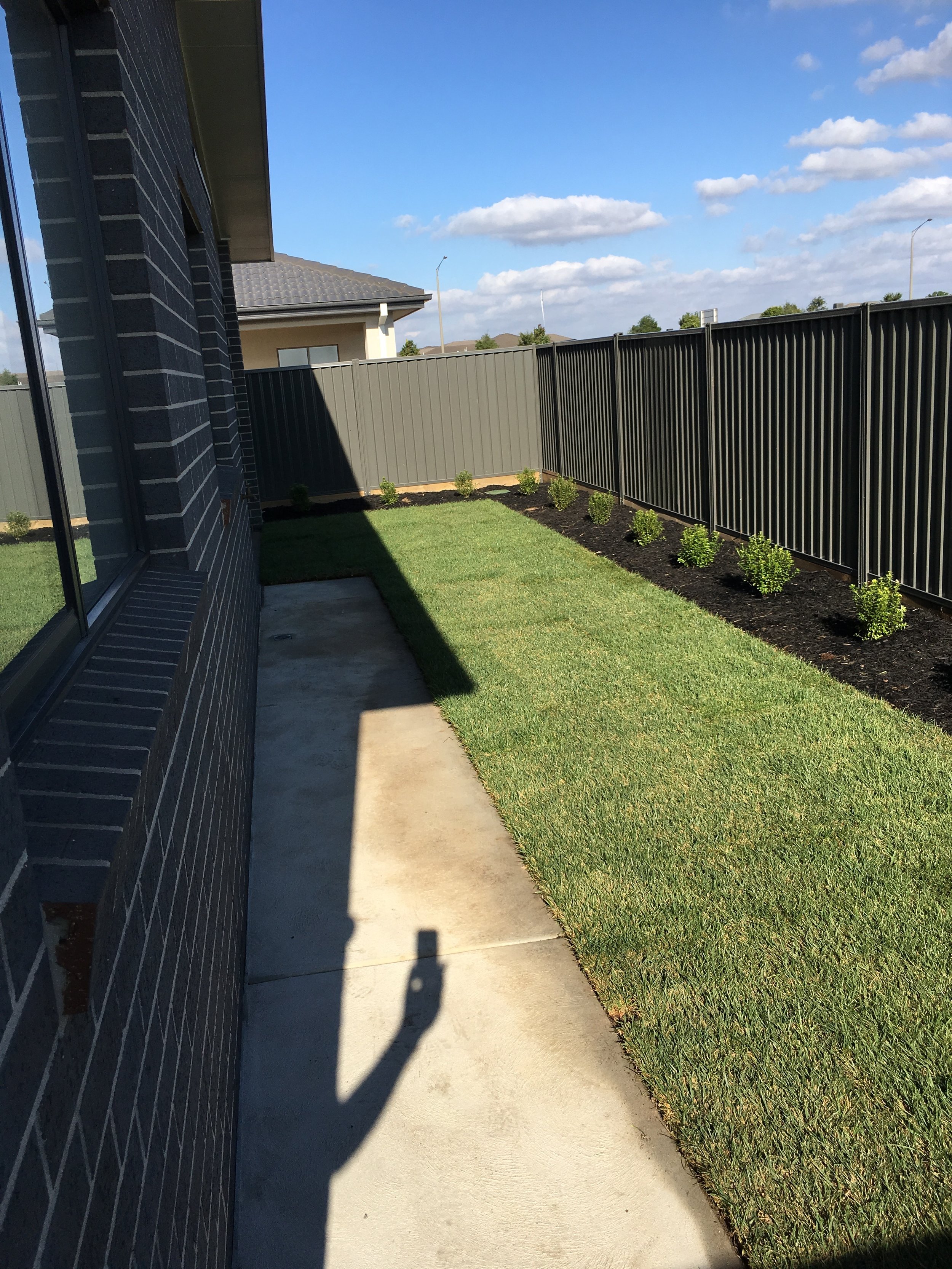 Instant turf and garden bed with black mulch