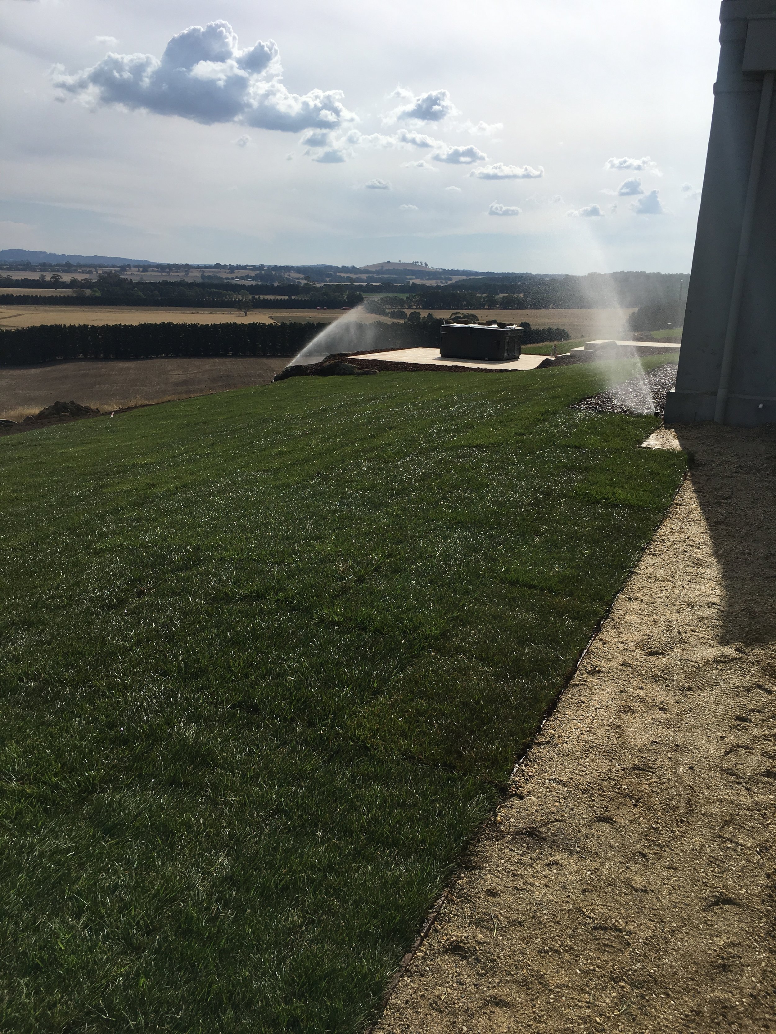 Instant turf with automated irrigation and tuscan toppings path