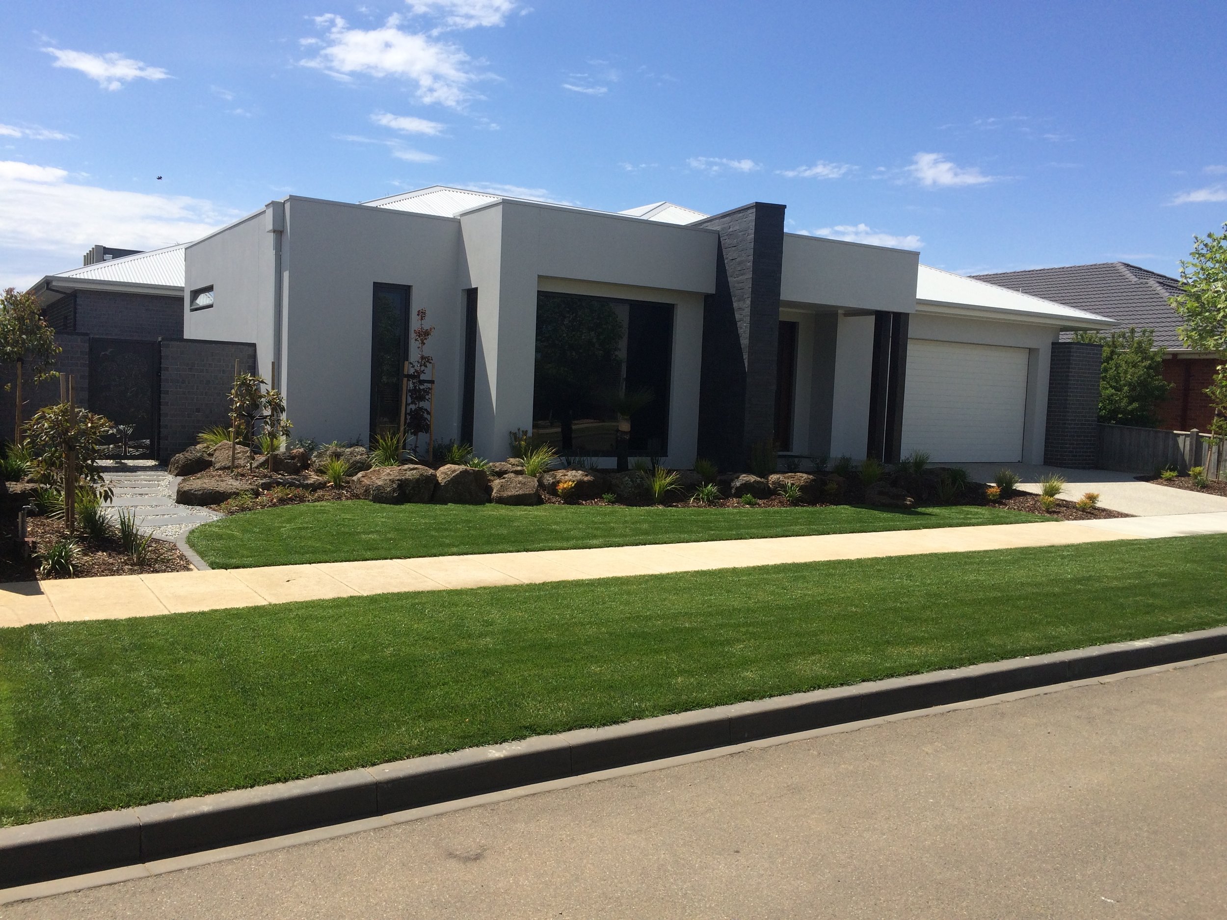 Instant turf, gardens with rocks and semi established trees, stepping pavers filled with pebbles