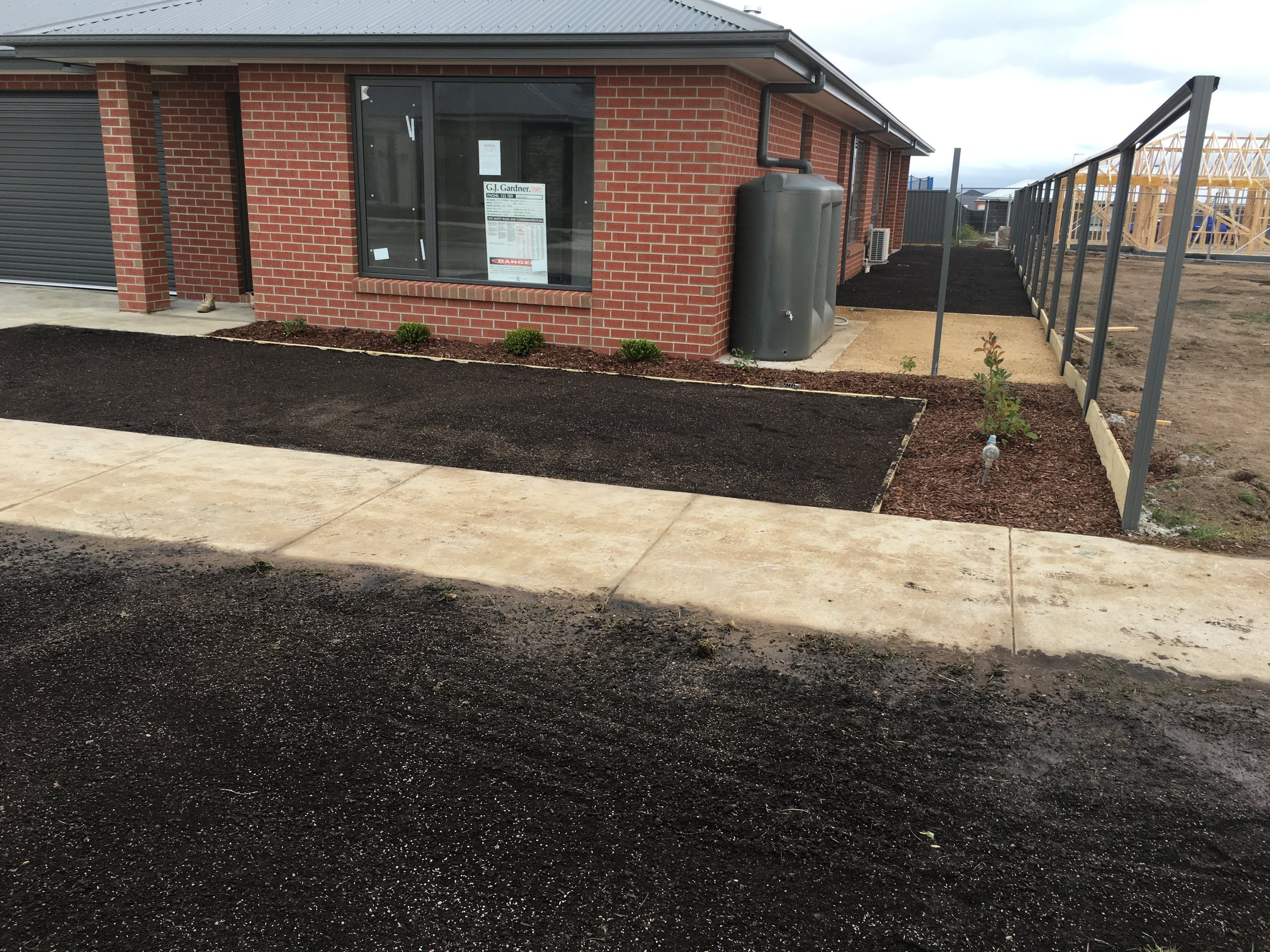 Progress shot installing garden bed and instant turf