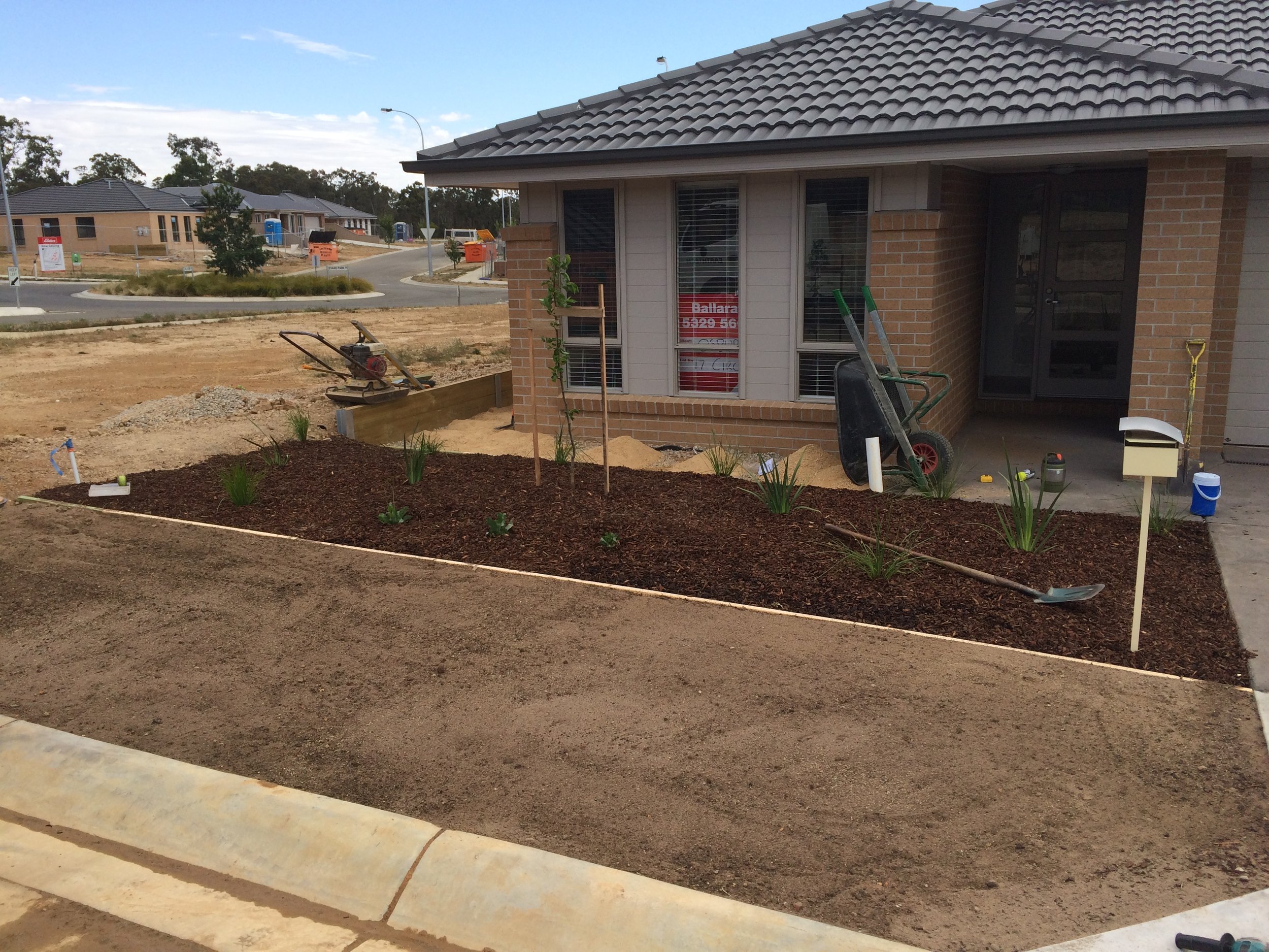 Progress shot installing garden bed and instant turf