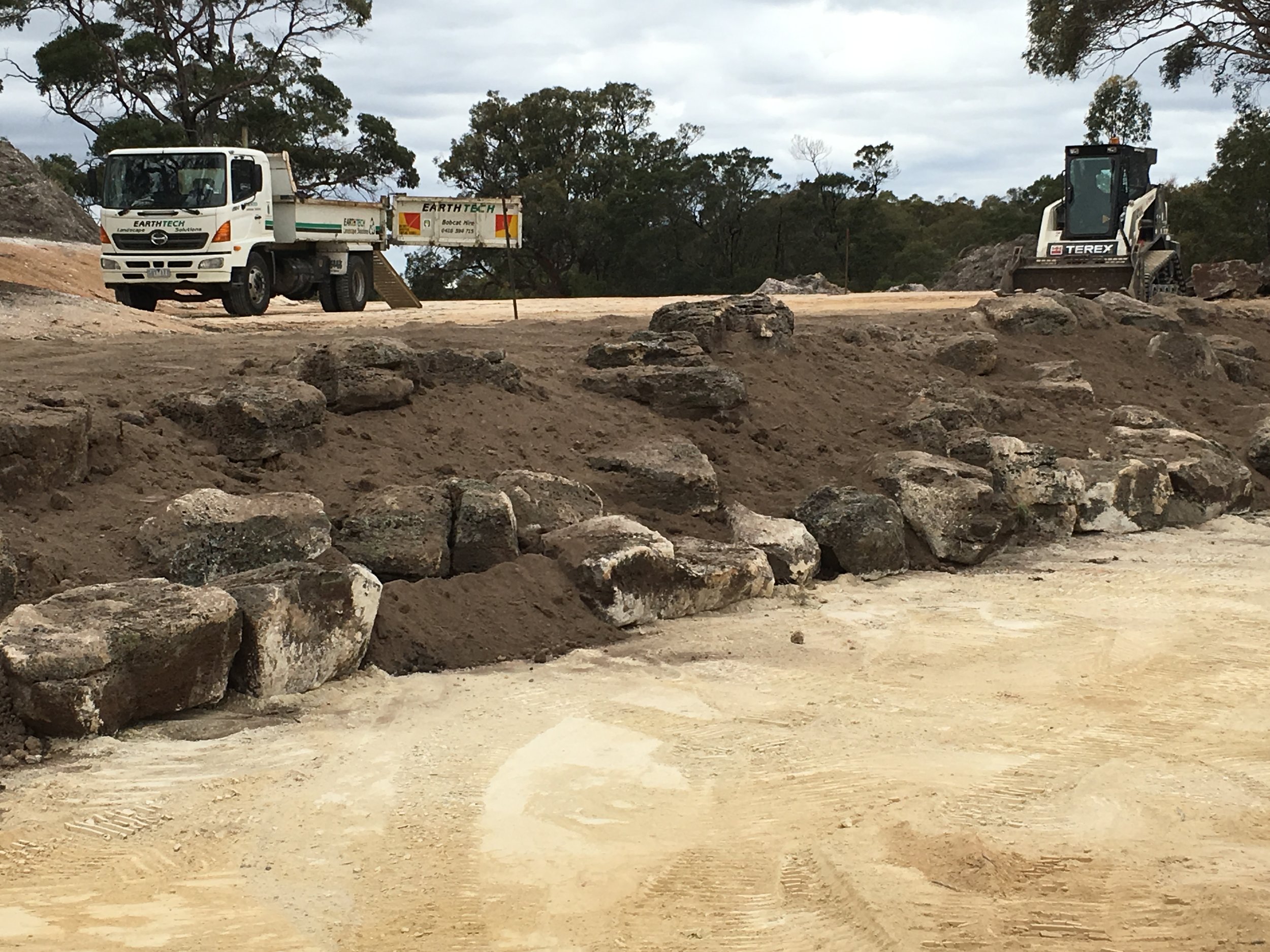 Progress shot installing rock retaining wall