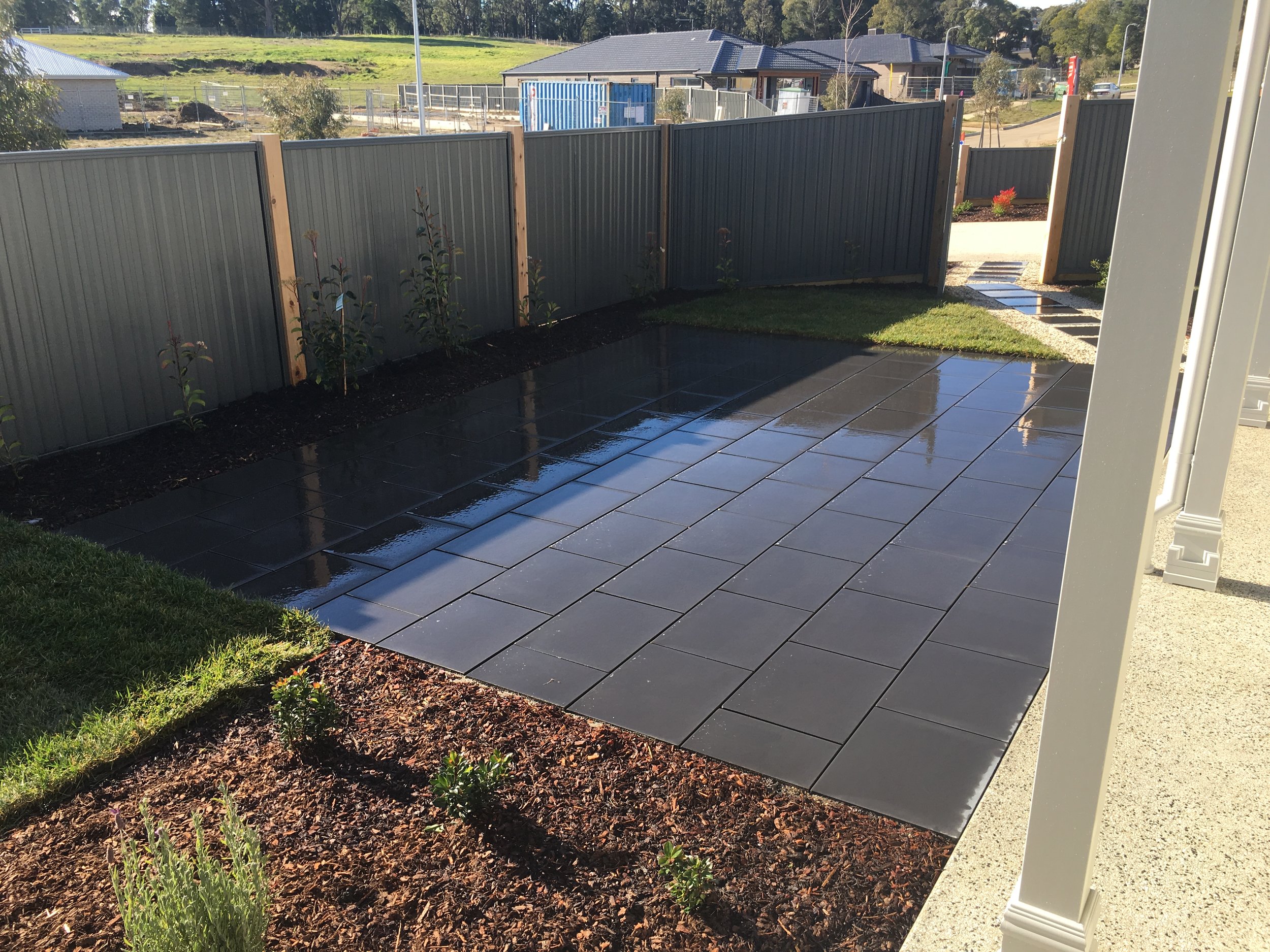 Paved area in stretcher bond style, mulched garden bed and instant turf