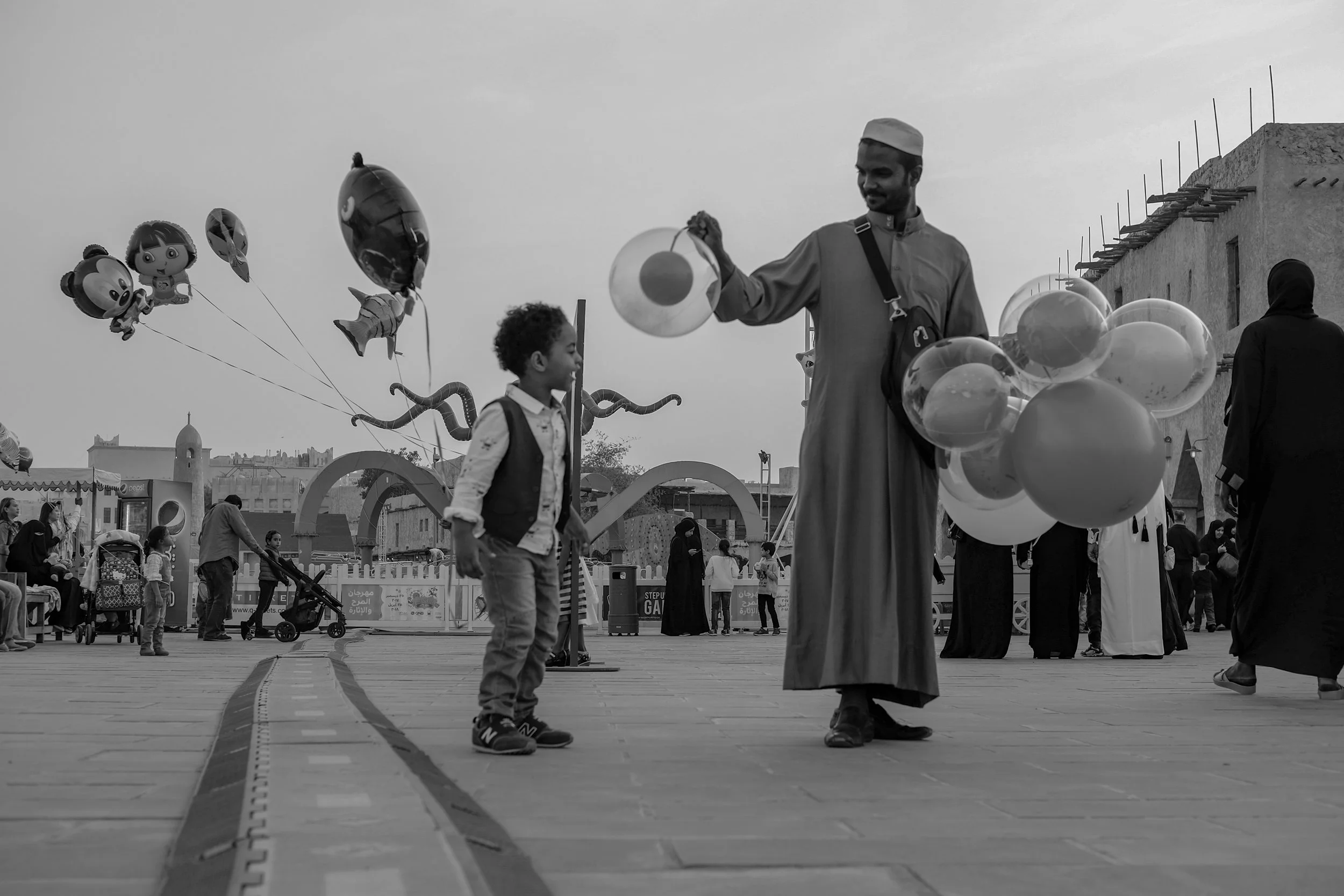 A balloon salesman and a boy in Souq Waqif, Doha.