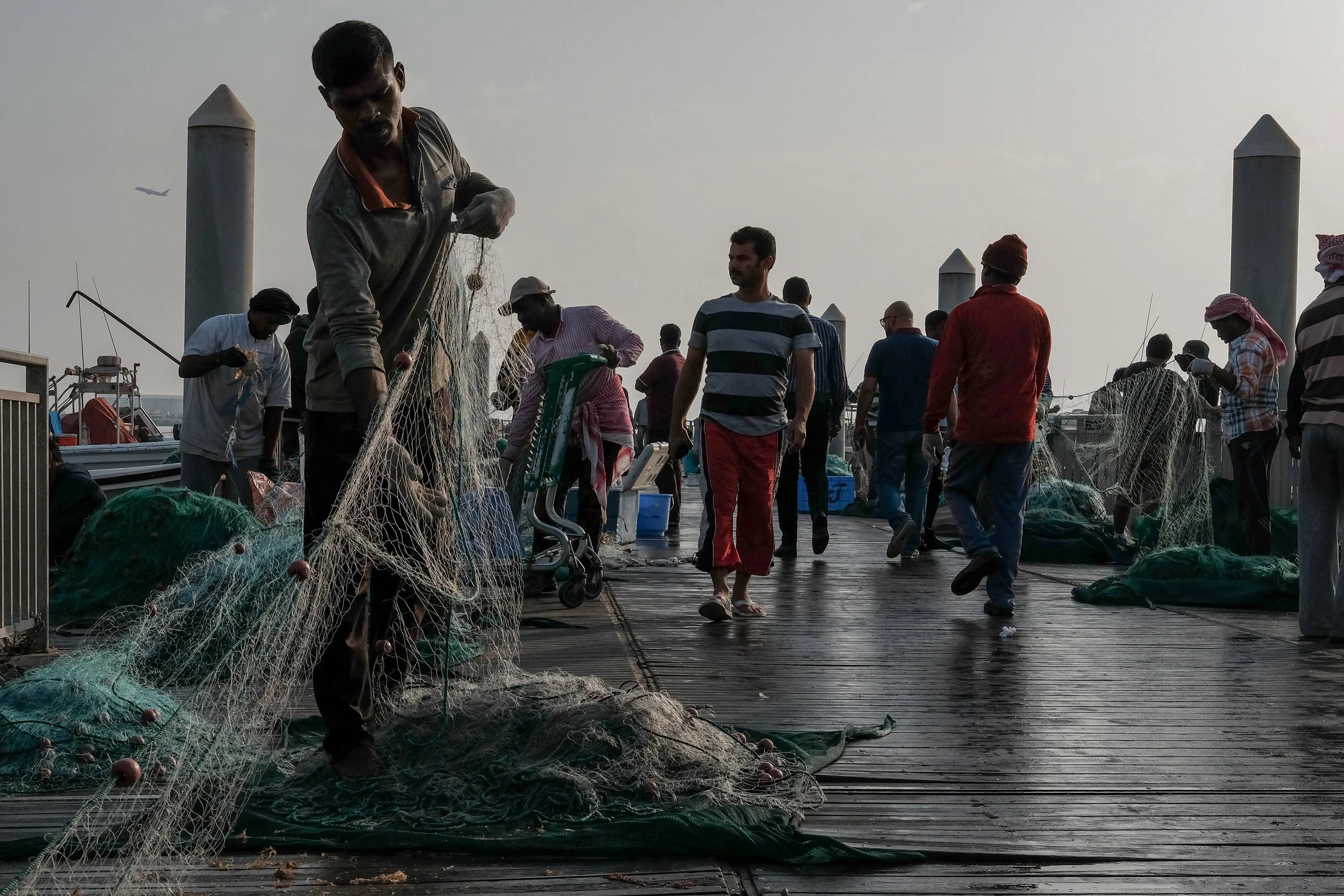 Fisherman untangles his nets at Doha's fish market on a Friday morning.&nbsp;