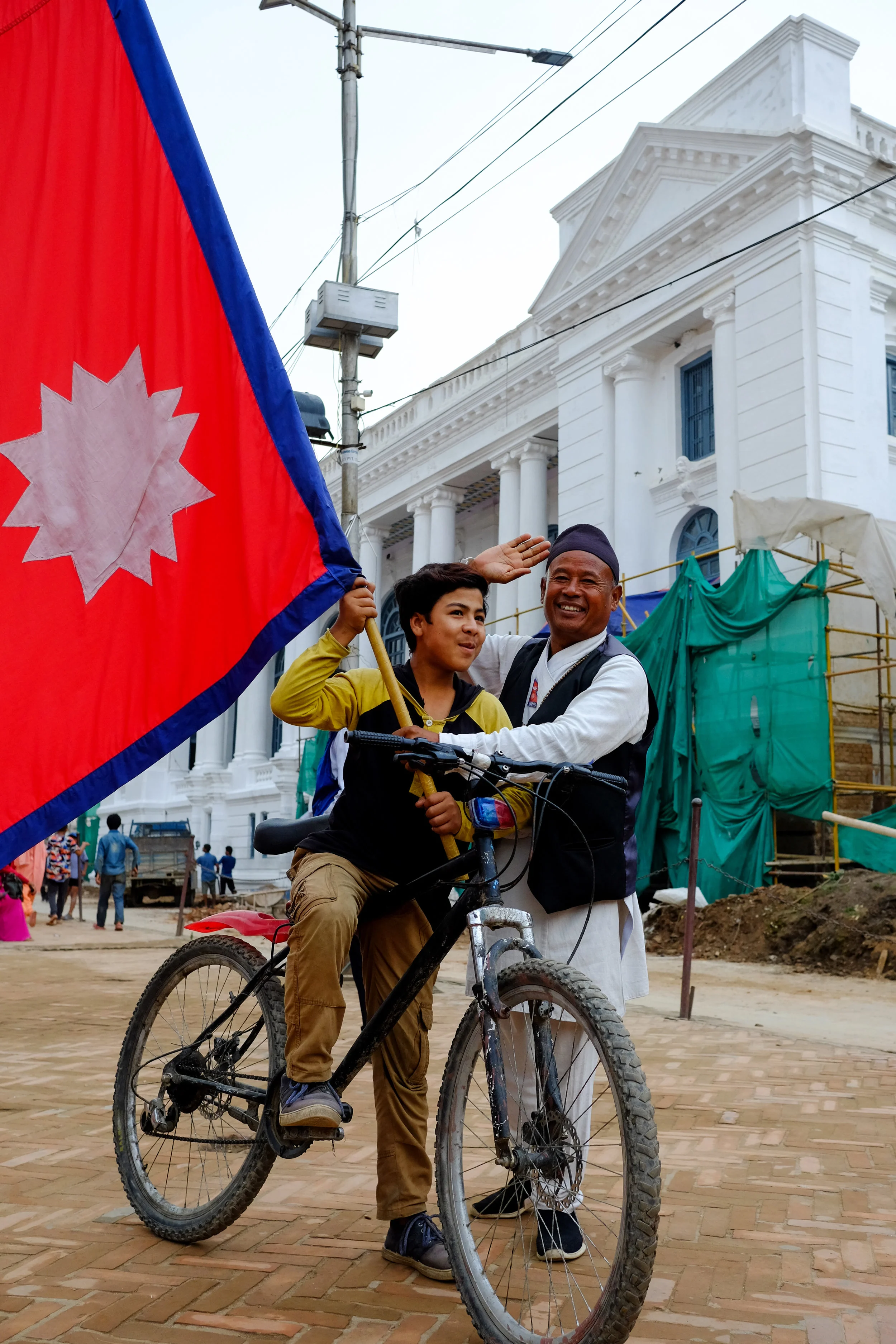 A Nepali boy with a flag seller in Durbar Square.