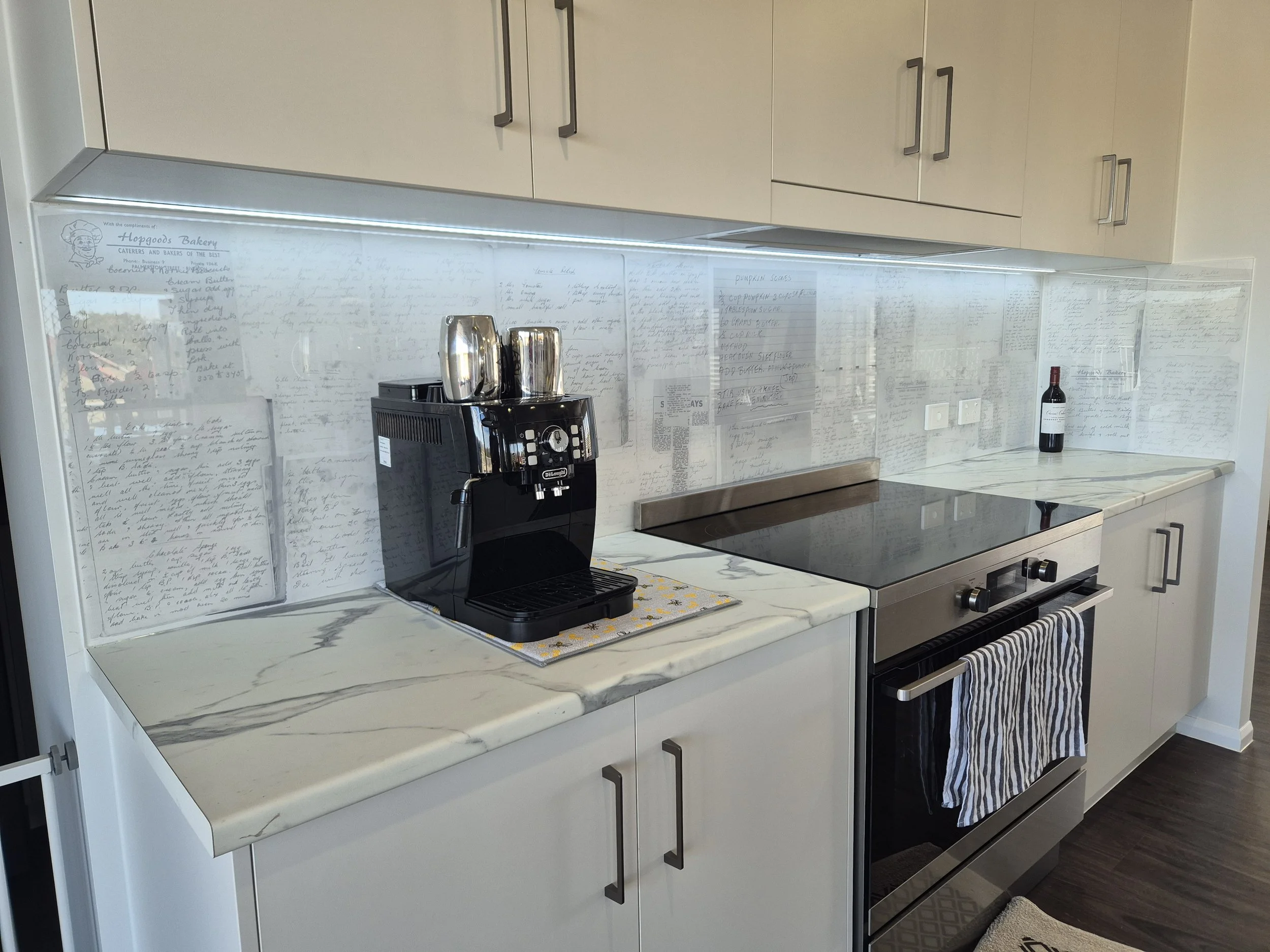 Printed acrylic kitchen splashback with family recipes collage