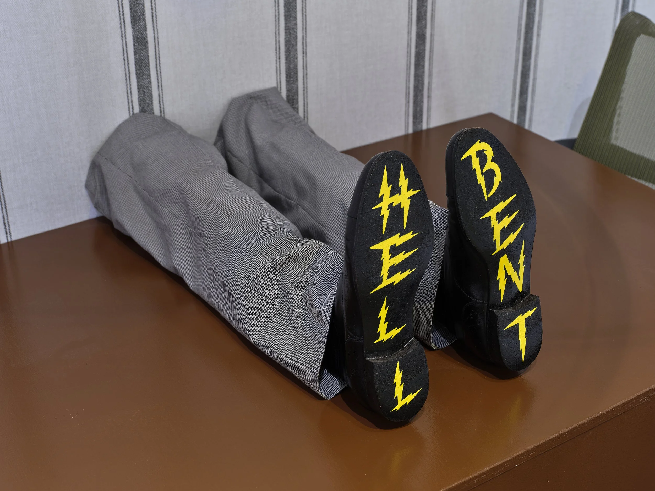  Lindsey White, Hell Bent, 2025, wood, enamel paint, shoes, desk chairs, audio 