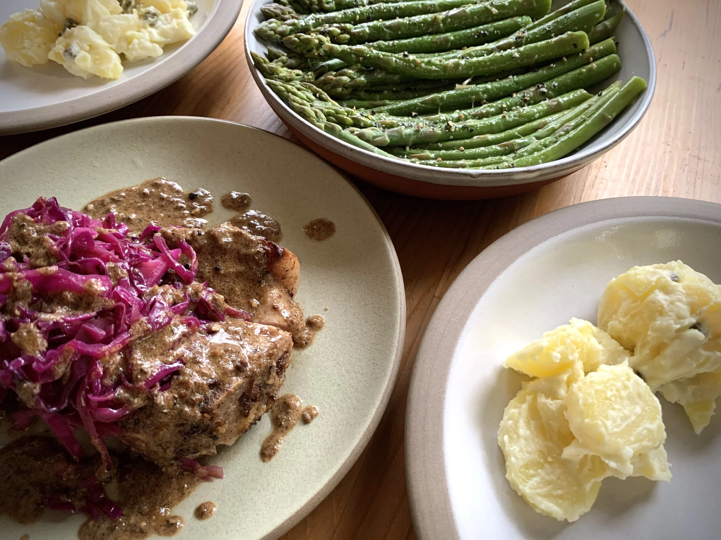 Dijon Pork Chops with Braised Cabbage, New Potato Salad, and Asparagus