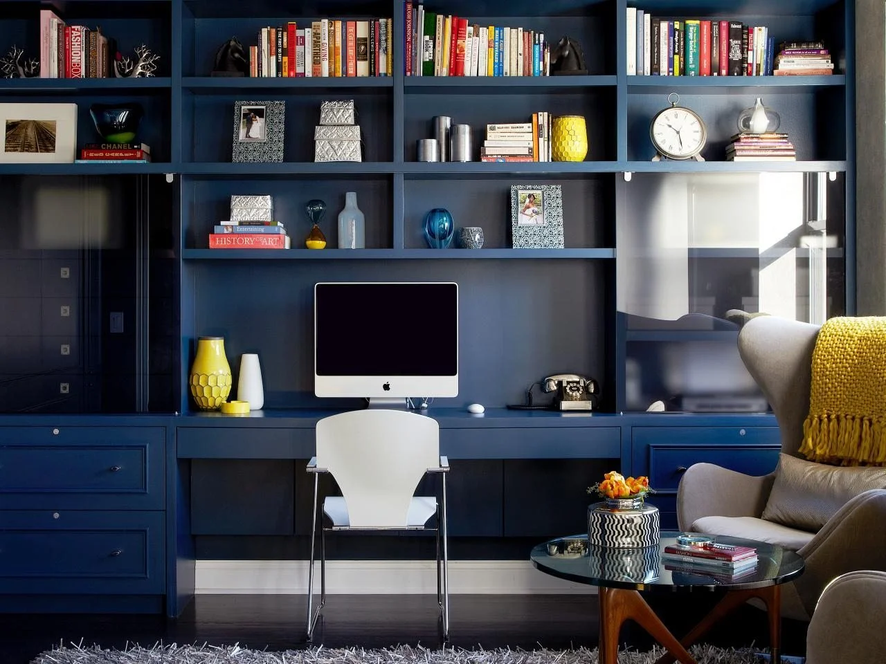 danielle-colding-navy-bookshelves-yellow-accents.jpeg